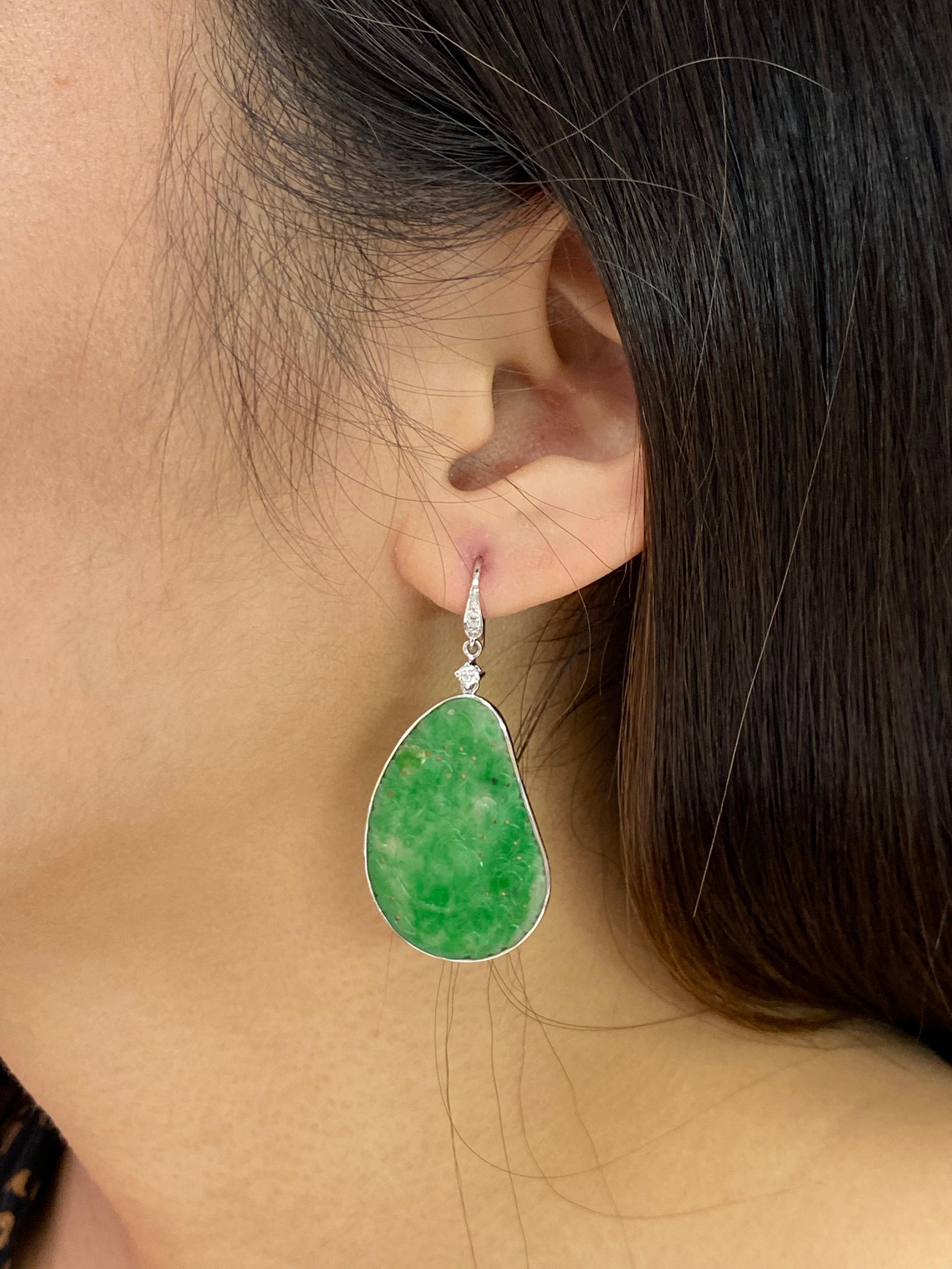 Vintage design using old materials. Here is a nice pair of Jade and diamond earrings. Both earrings are set in 18k white gold and diamonds. There are estimated 0.20 cts of diamonds in this setting. There are 8 diamonds in total, 6 of them total 0.8