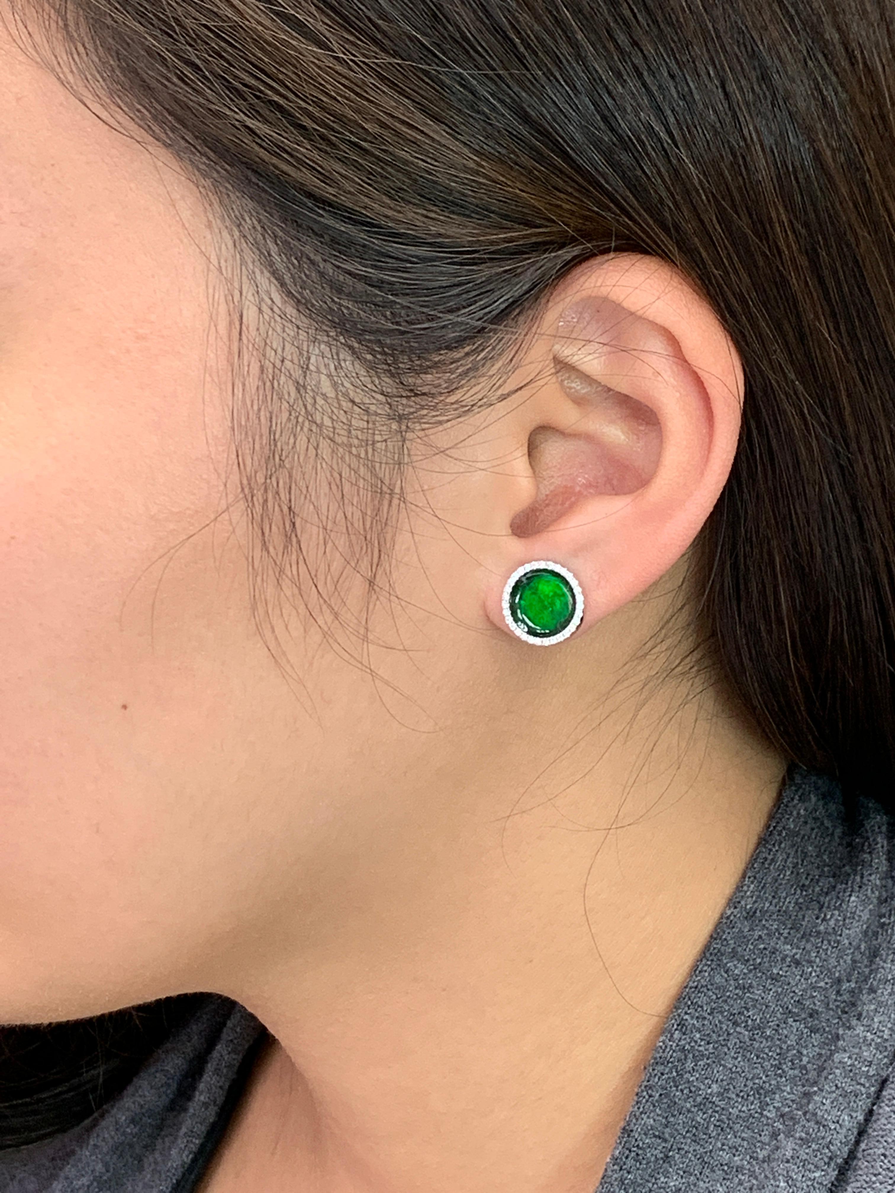 Here is a nice pair of spinach green Jade earrings. The diameter is about 12mm each. The earrings are set in 18k white gold and diamonds. The untreated / unenhanced natural jade is translucent. The color is spinach green. These jade are full of