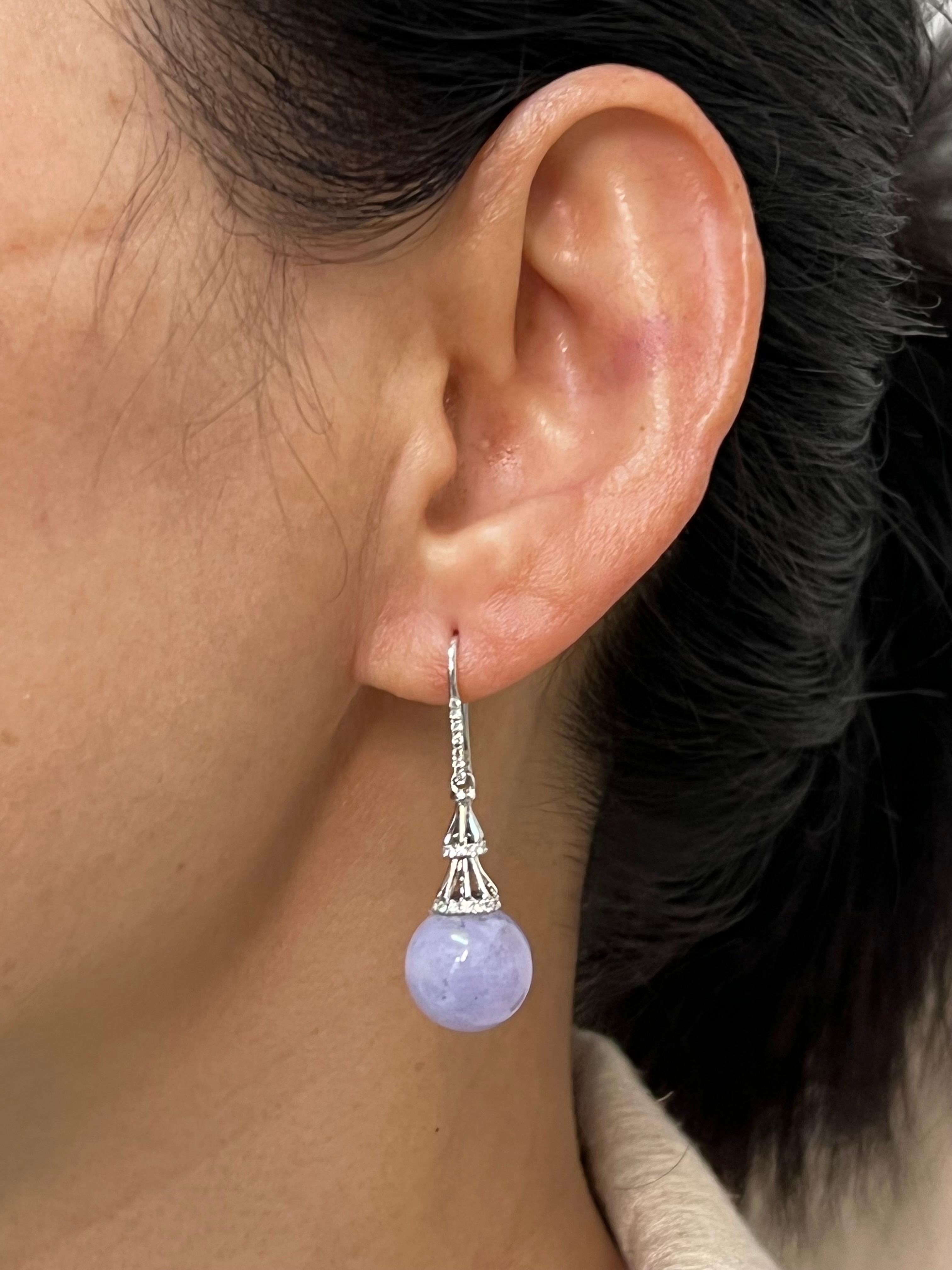 Please check out the HD video. This is a very special pair of drop earrings are well designed combined with top material. The lavender / purple jade beads in these earrings are certified to be natural. The earrings are set in 18k white gold. The 2