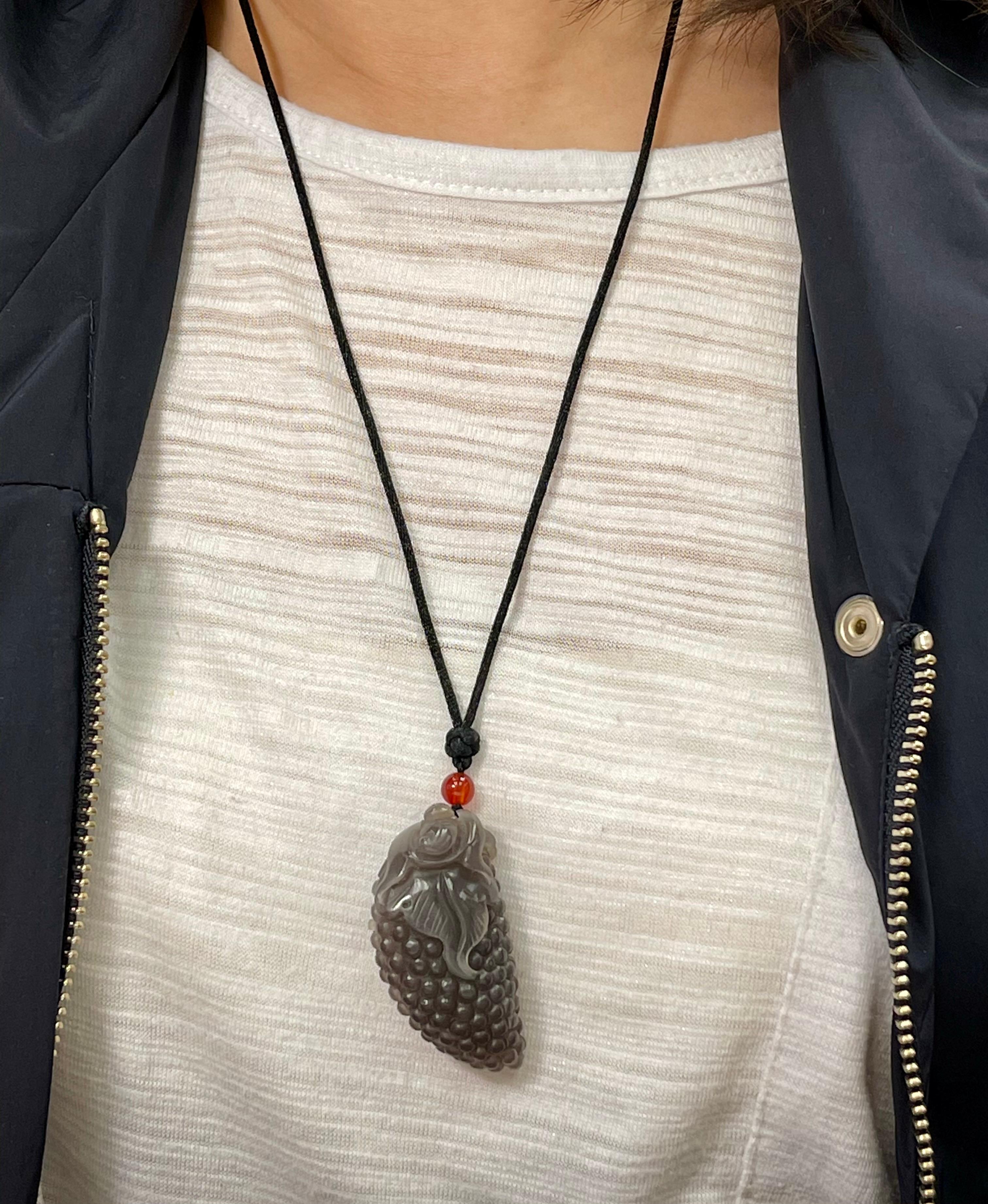 Nephrite Jade comes in many different colors. This grayish, brownish Black is a color you don't see often. Besides the unusual color, this jade is also translucent. The nephrite jade necklace is well carved. The carving depicts a bat (prosperity)