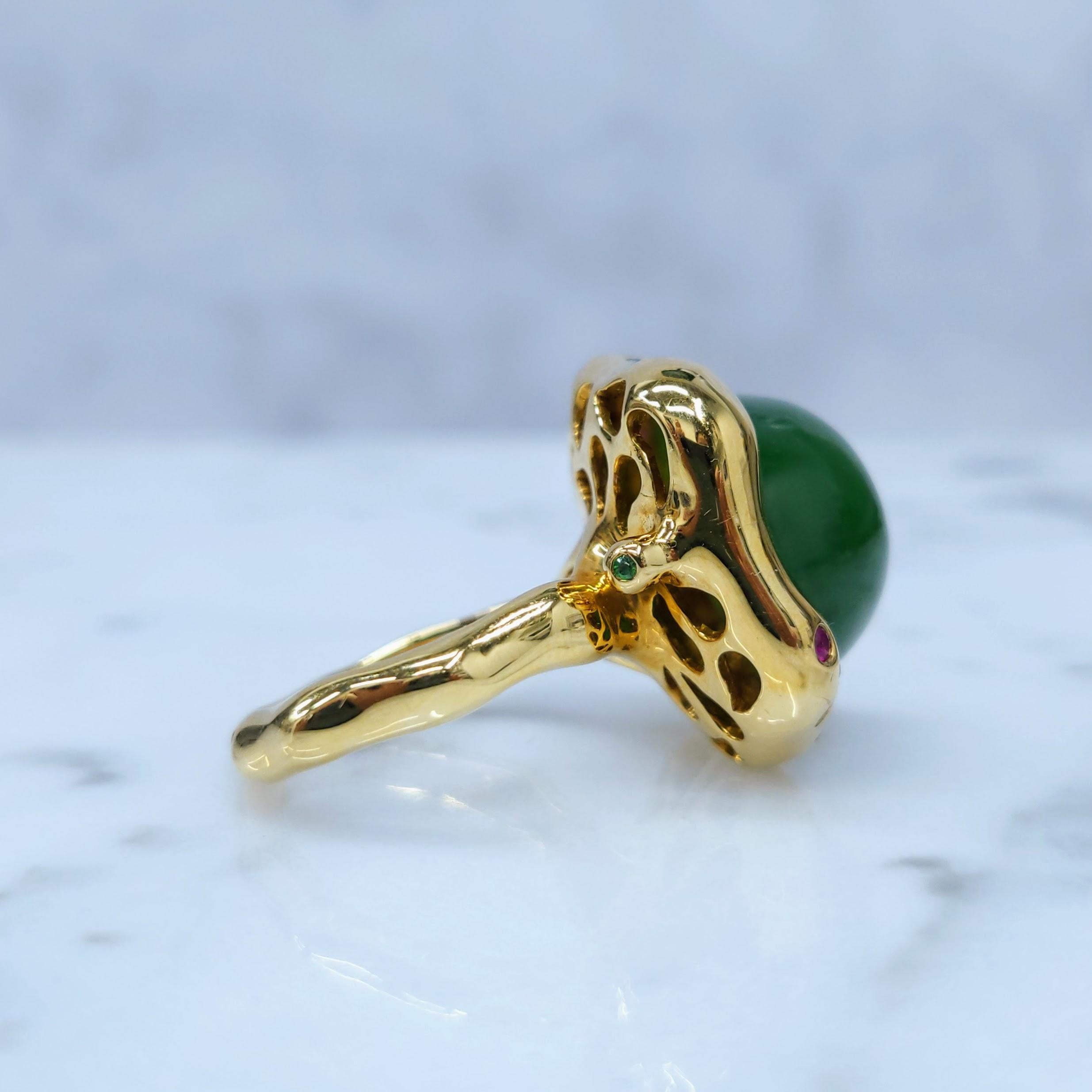 This exquisite ring showcases a stunning piece of natural nephrite jade, a gemstone revered for its beauty and durability. The jade is set in a classic cabochon cut, allowing its natural color and translucency to shine.

This ring features a unique