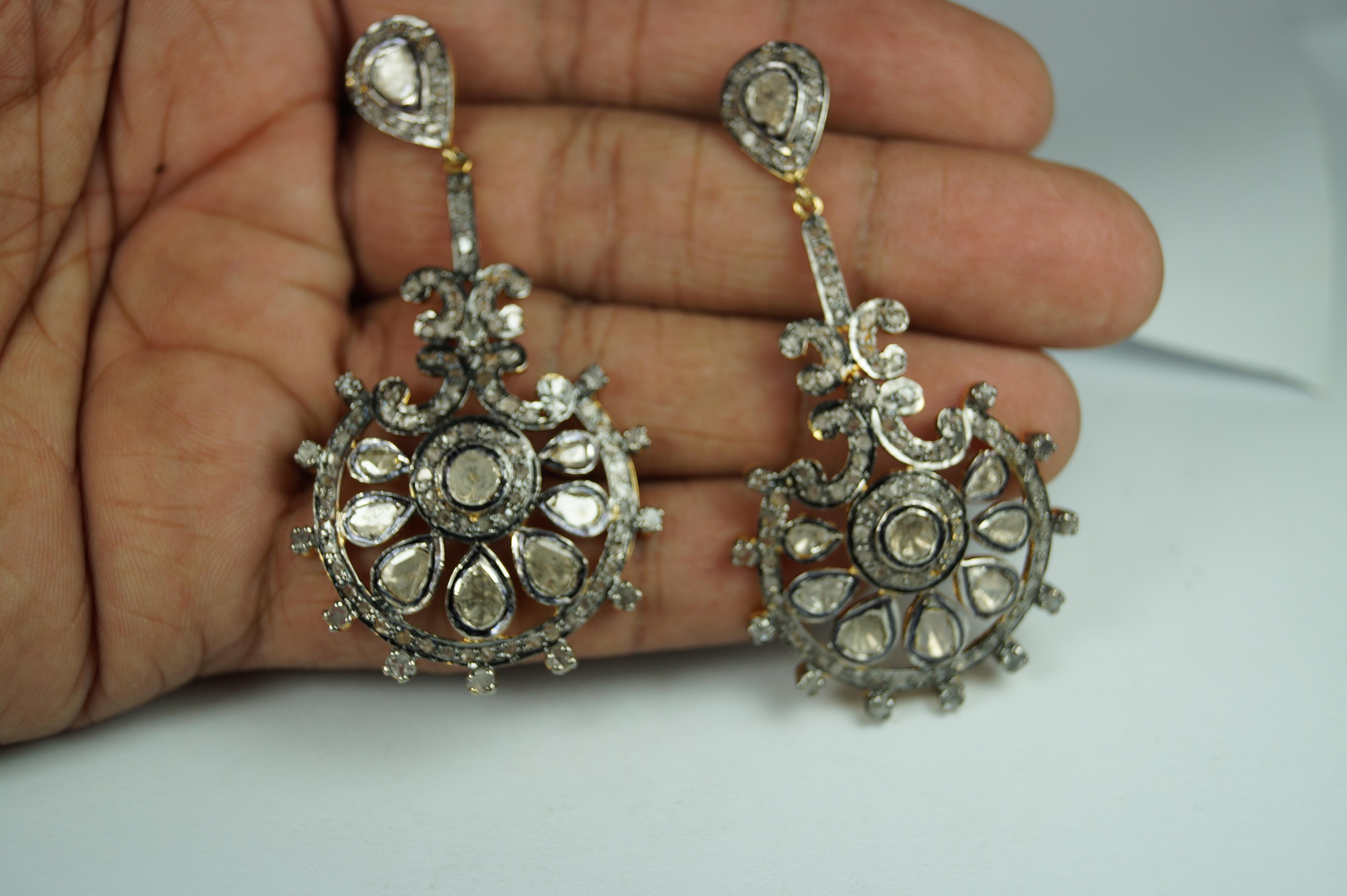 Stunning diamond sterling silver earrings consists of :

Metal- Silver
Metal Purity- sterling silver
Color of metal- oxidized silver look and Yellow gold plating 
Diamond- Natural uncut diamonds and rose cut diamonds
Diamond origin- Natural earth