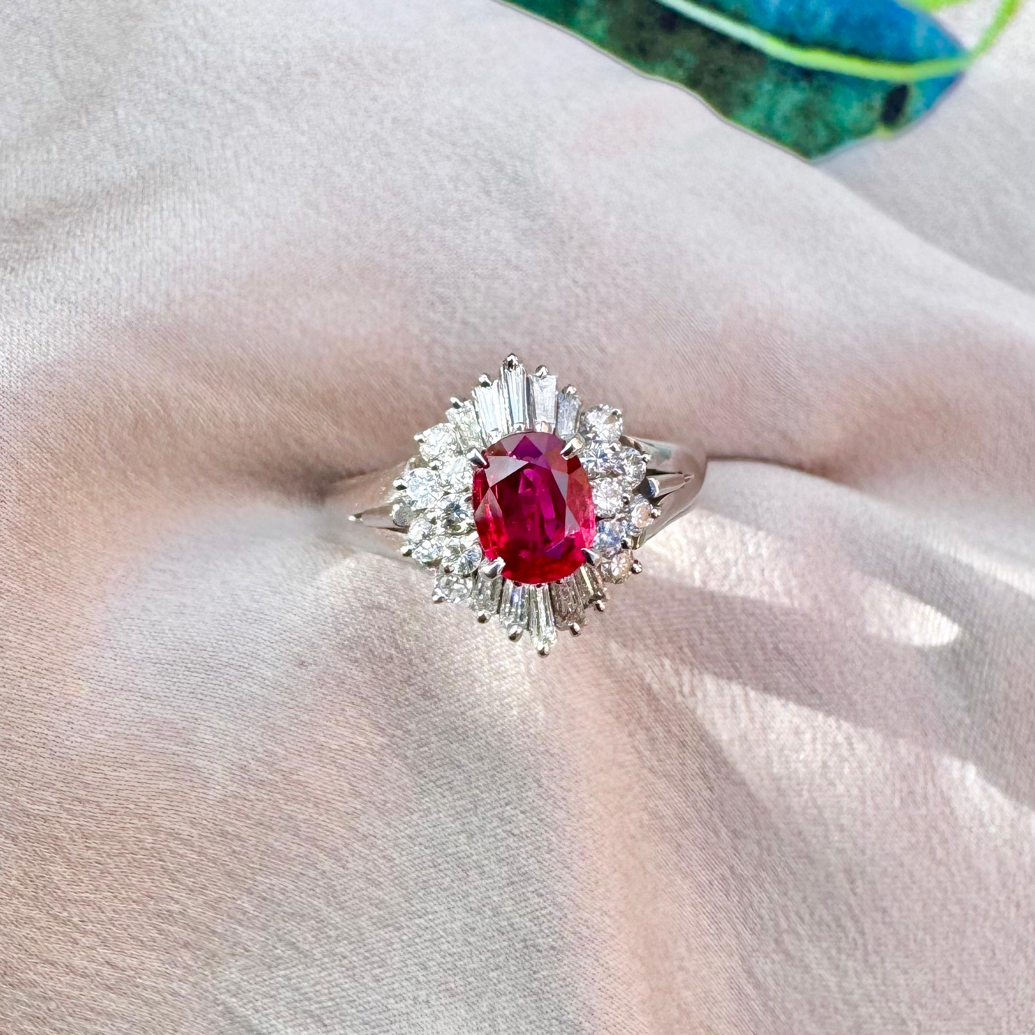 A stunning and sparkling, vintage Ruby and diamond halo ring, set in a classic and timeless platinum setting. 

Specifications: 
Weight of Ruby: 0.64 carats
Diamond Weights: 0.49 carats 
Metal Type: Platinum 
Pre-Owned Jewelry Condition: