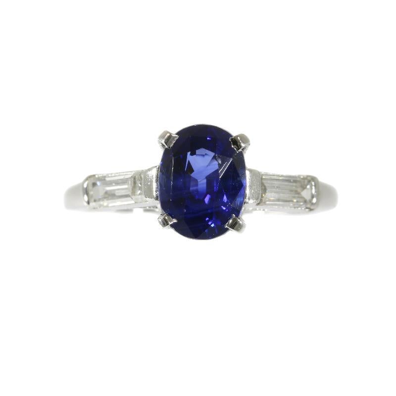 A vintage engagement ring in platinum set with a certified natural untreated sapphire weighing 1.93 carat and 2 baguette cut diamonds totaling 0.45 carat (colour and clarity: G/I, vs/si). The ring is stamped '10% irid plat' refering to the platinum