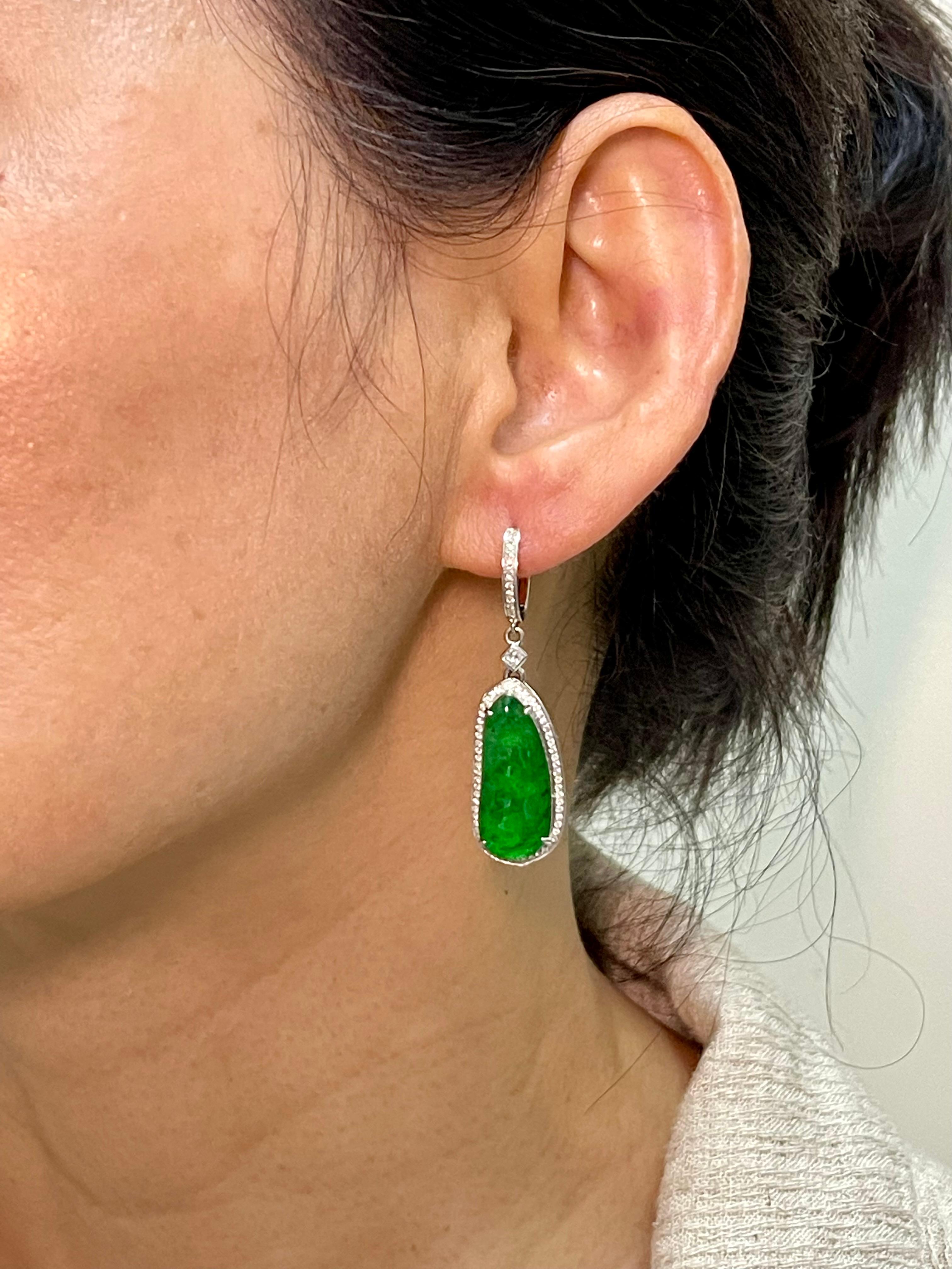 These icy jade apple green earrings are certified by 2 labs. Here is a nice pair of apple green Jadeite Jade earrings. The earrings are set in 18k white gold, and white diamonds. The 2 jade peapods glows. The icy jade peapod carving represents