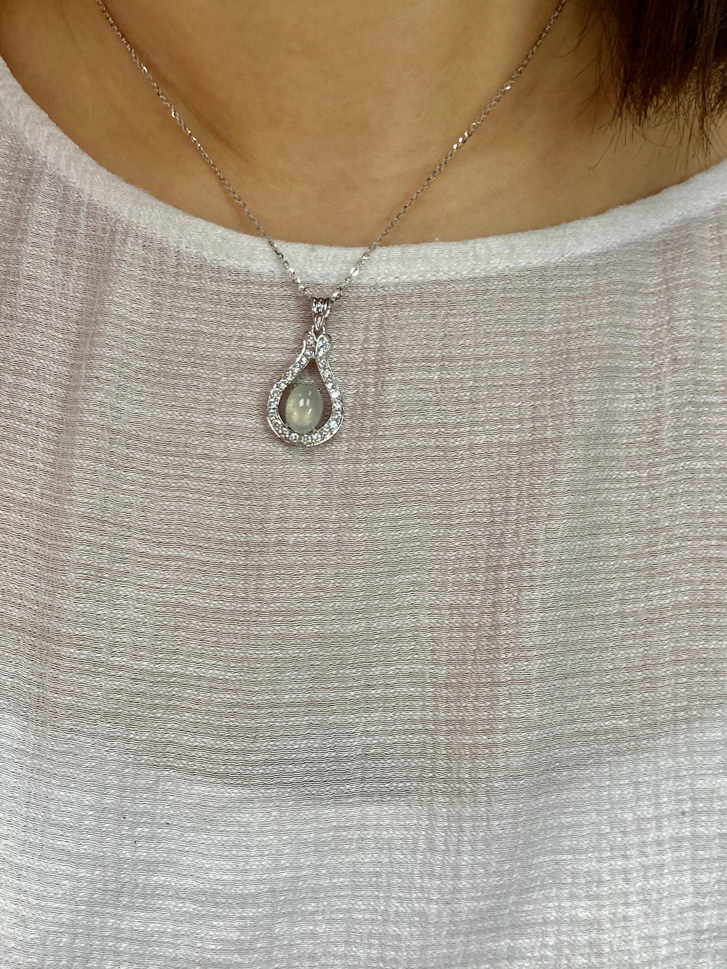 Here is a natural icy Jade and diamond pendant. The jade is certified. The lucky horseshoe pendant is set in 18k white gold and diamonds. There are 0.61 Cts of diamonds set in this drop pendant. The untreated / unenhanced natural jade is translucent
