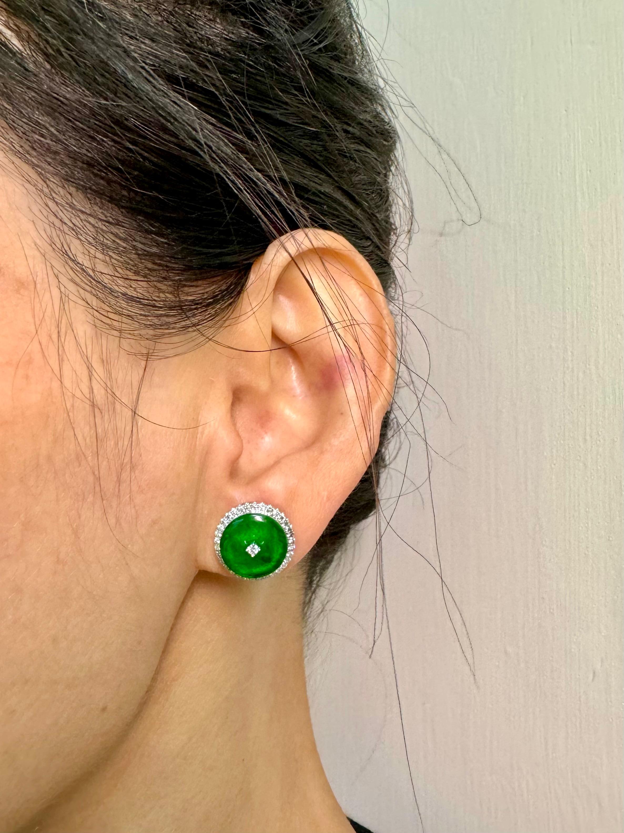 Please check out the HD video! Here is a nice pair of bright apple green Jade earrings. Each earring is about 14mm. The earrings are set in 18k white gold and diamonds. There are 67 white brilliant diamonds totaling 0.44Cts that make up the halo.