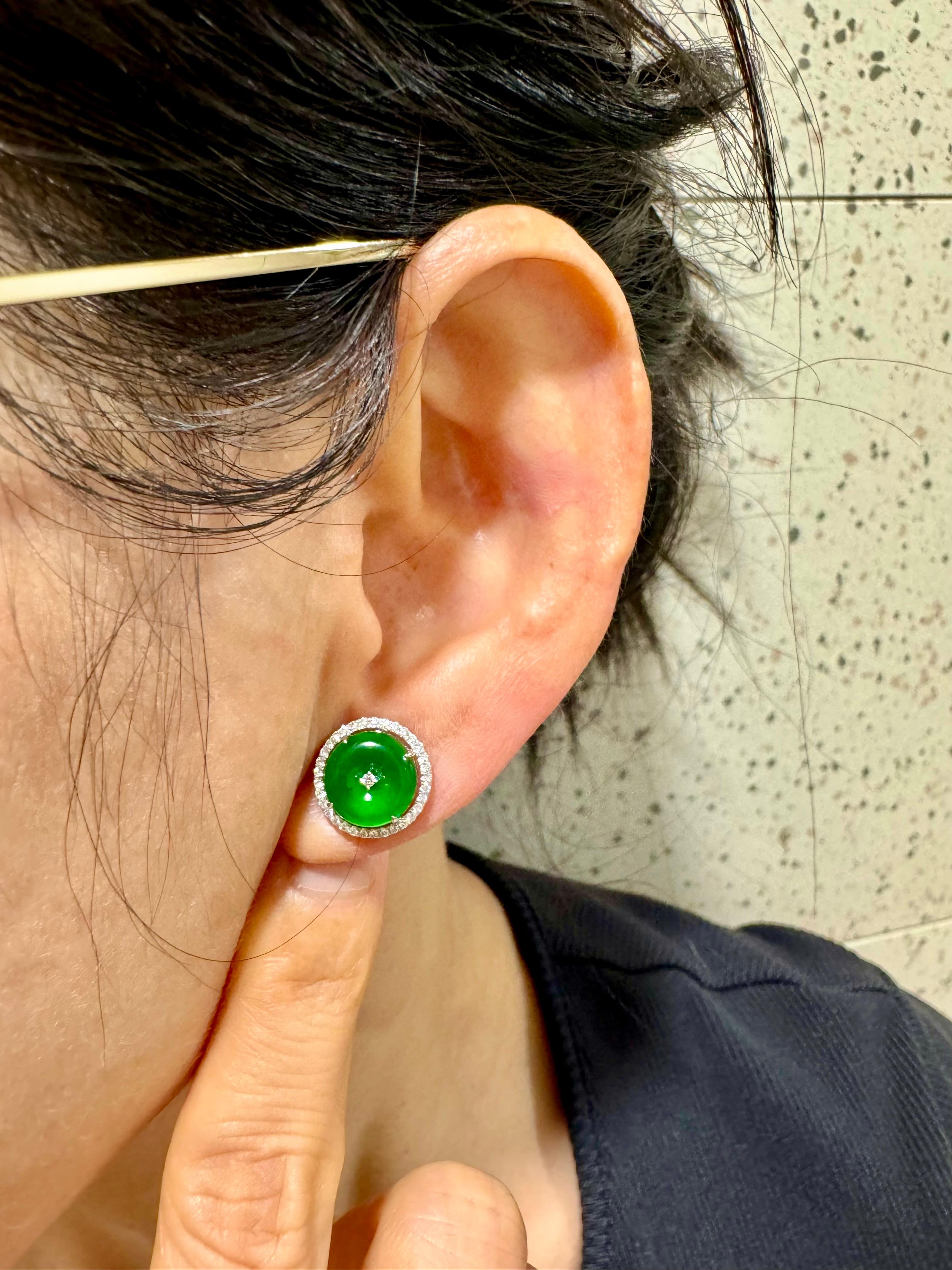 Please check out the HD video! Here is a nice pair of bright apple green Jade earrings. Each earring is about 12mm. The earrings are set in 18k white gold and diamonds. There are 2 diamonds in the middle totaling 0.02cts and an additional 67 white