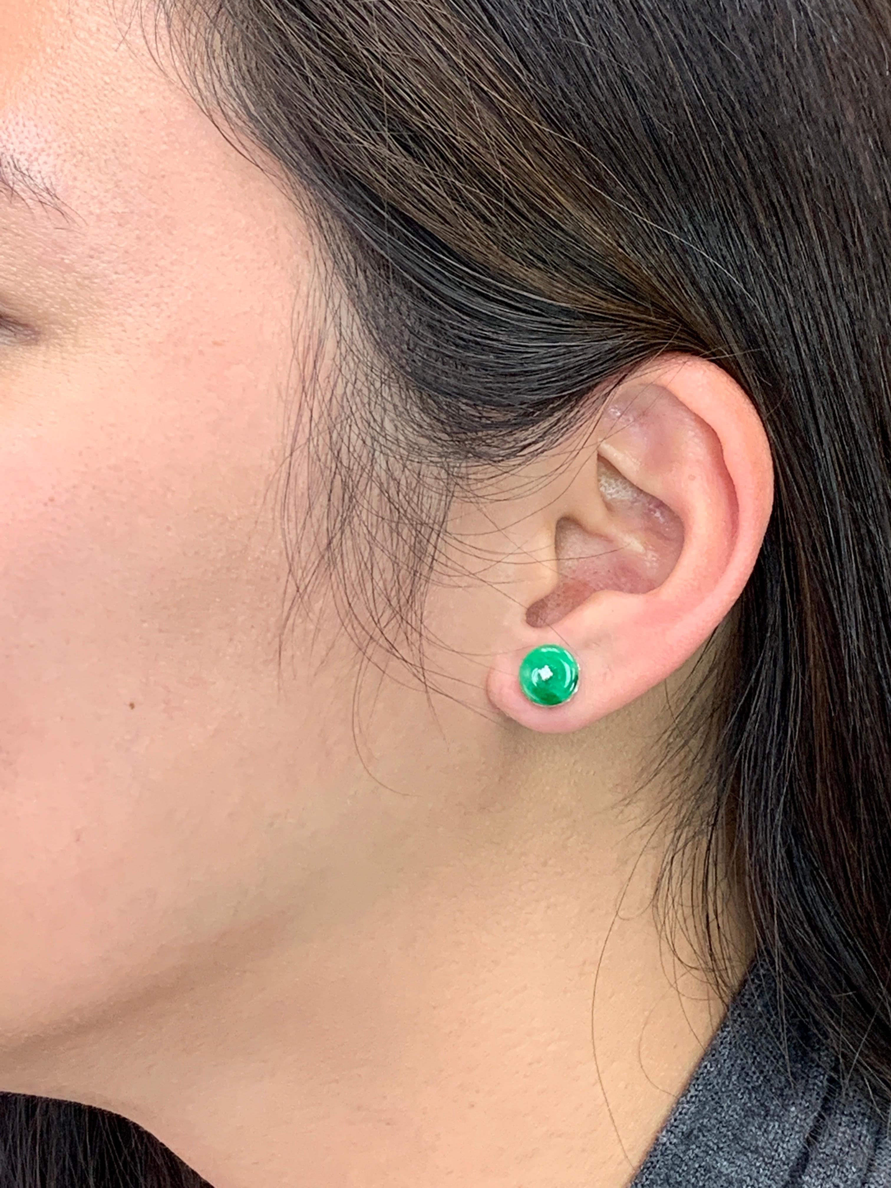 This is a pair of spinach green Jade earrings. It is made recently using old jade material. The diameter is about 9.1 mm each. The earrings are set in 18k white gold and diamonds. There is one single diamond in the middle of each earring. The