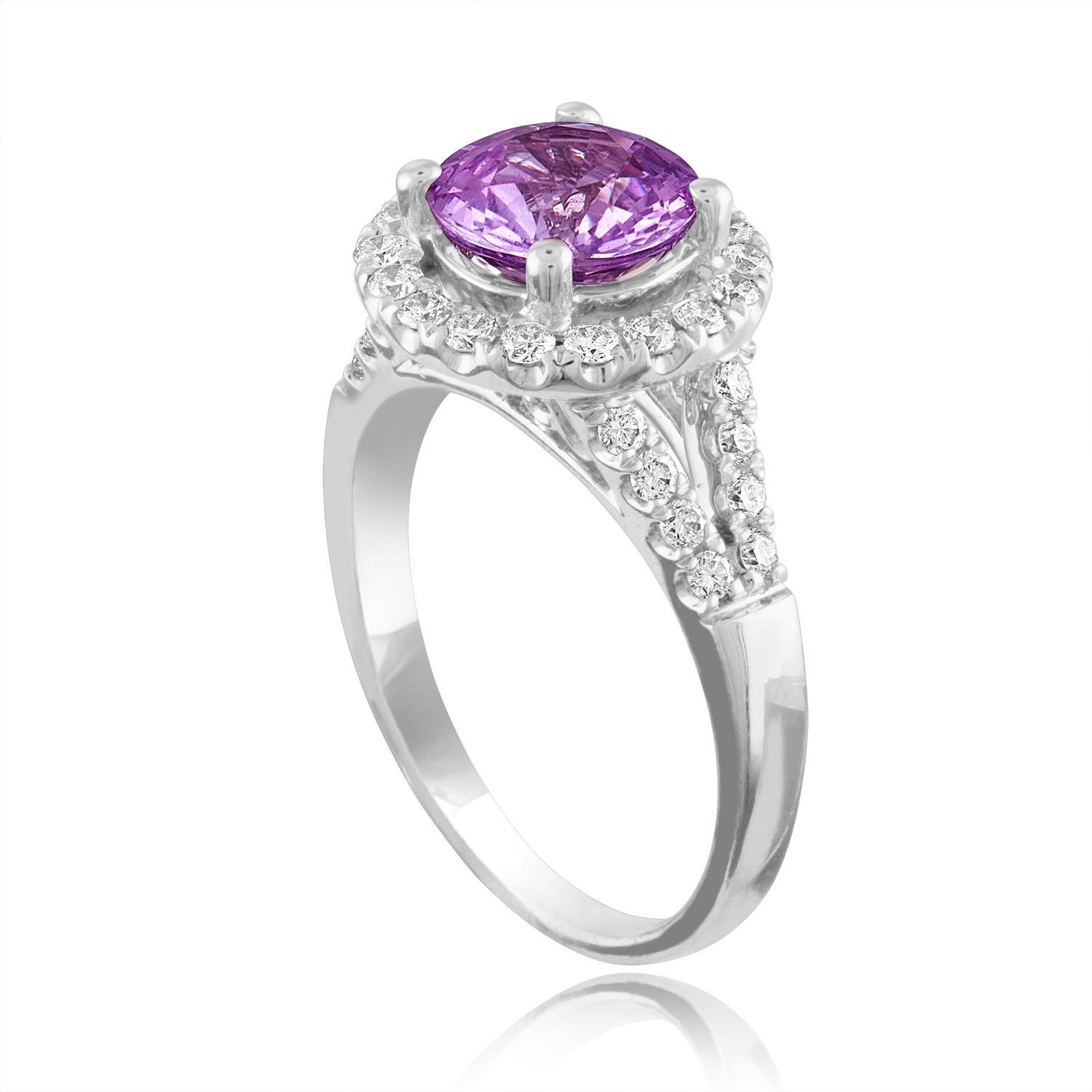 Exquisite Pink Sapphire Halo Ring
The ring is 18K White Gold Ring
The sapphire is a round 2.18 Carats
The sapphire is Pink in color No HEAT
The stone is certified by LAPIS.
The Sapphire changes color depending on light.
There are 0.60 Carats in
