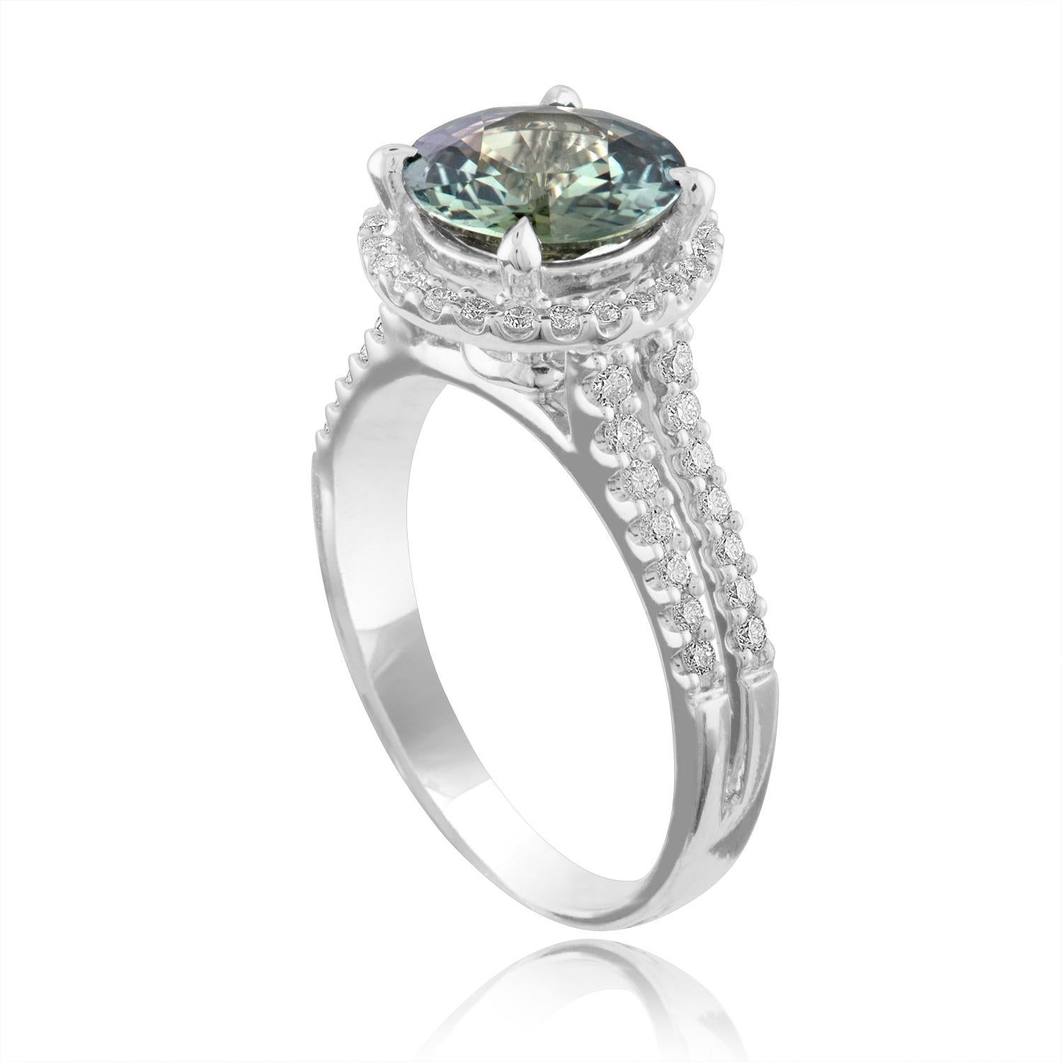 Exquisite Bluish Green Sapphire Halo Ring
The ring is 18K White Gold Ring
The sapphire is a round 2.56 Carats
The sapphire is Bluish Green in color No HEAT
The stone is certified by LAPIS.
The Sapphire changes color depending on light.
There are