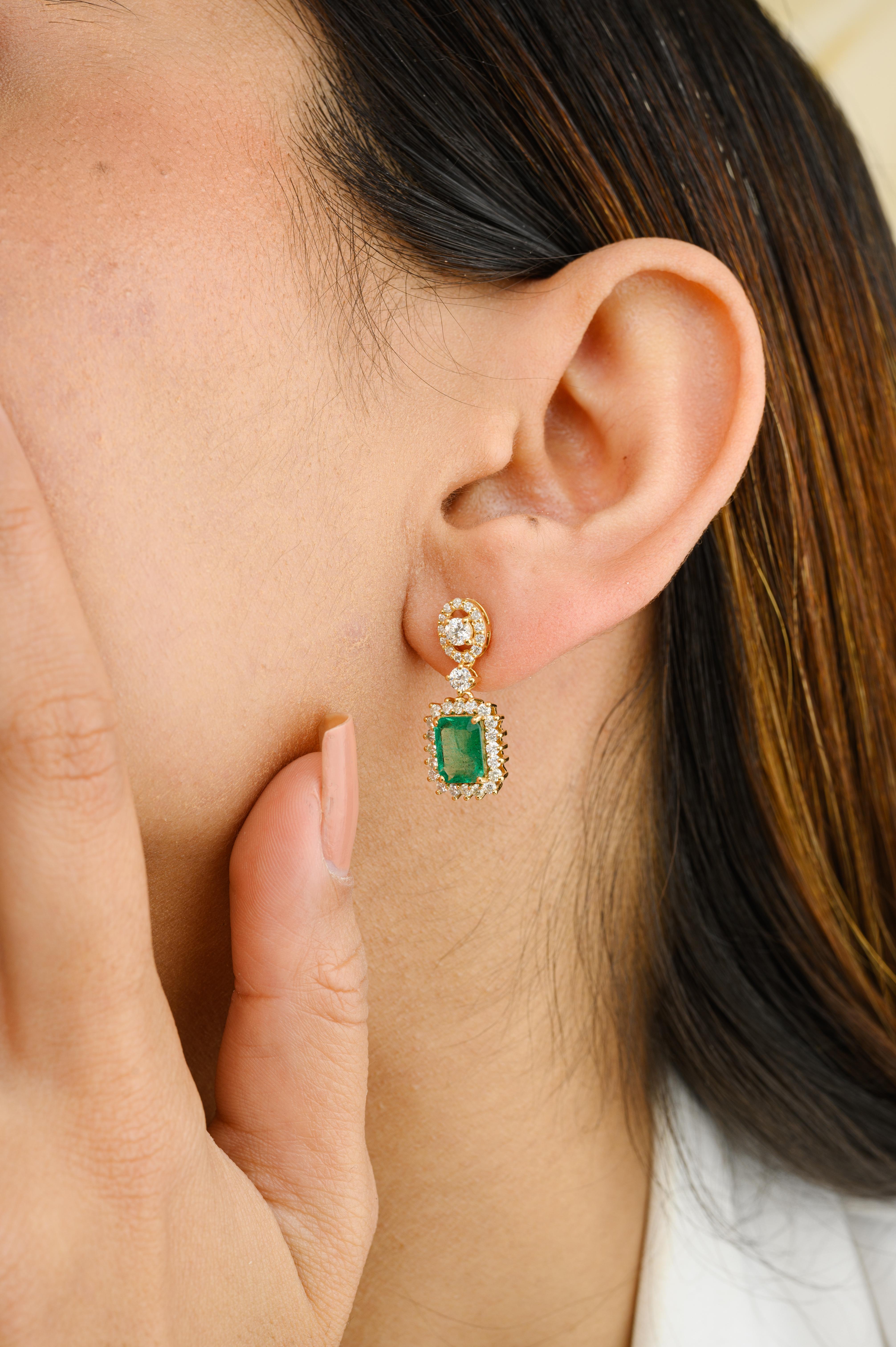 Certified Octagon Emerald and Diamond Halo Dangle Earrings in 18K Gold to make a statement with your look. You shall need dangle earrings to make a statement with your look. These earrings create a sparkling, luxurious look featuring octagon cut