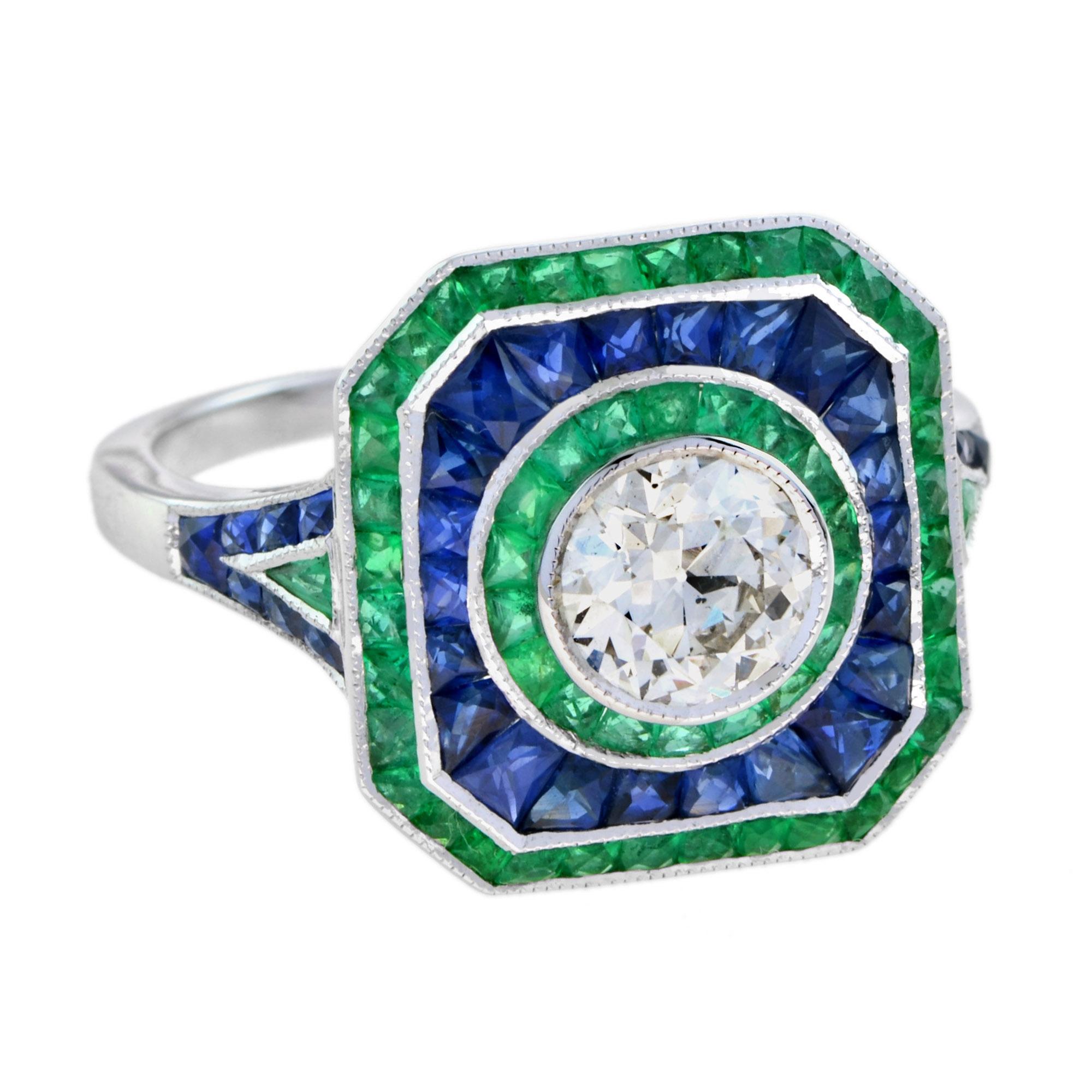 A fantastic tricolor antique style diamond ring. The unusual octagonal outline certainly gives it an Art Deco look. Three rows individually channel set with emeralds an blue sapphires. Finished in the center with beautiful old cut round shape