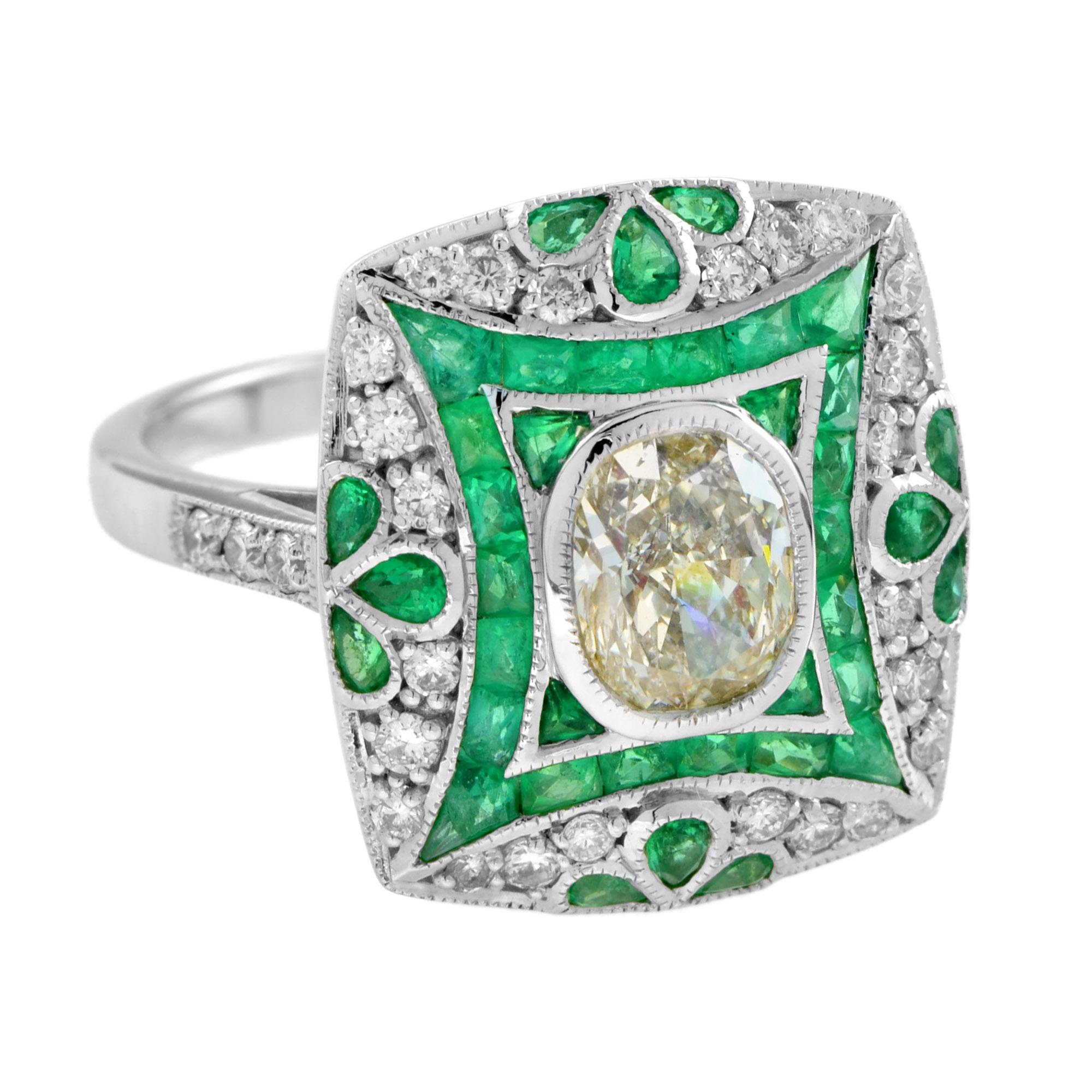 In this artful Vintage inspired ring, an oval shaped diamond glitters from the center of 18k white gold setting accented by French cut emeralds and round diamonds. The emeralds were add for its lively green leaves motif, producing a beautiful and