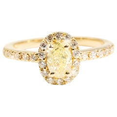Certified Oval Yellow Diamond and Round White Diamond Halo Engagement Ring