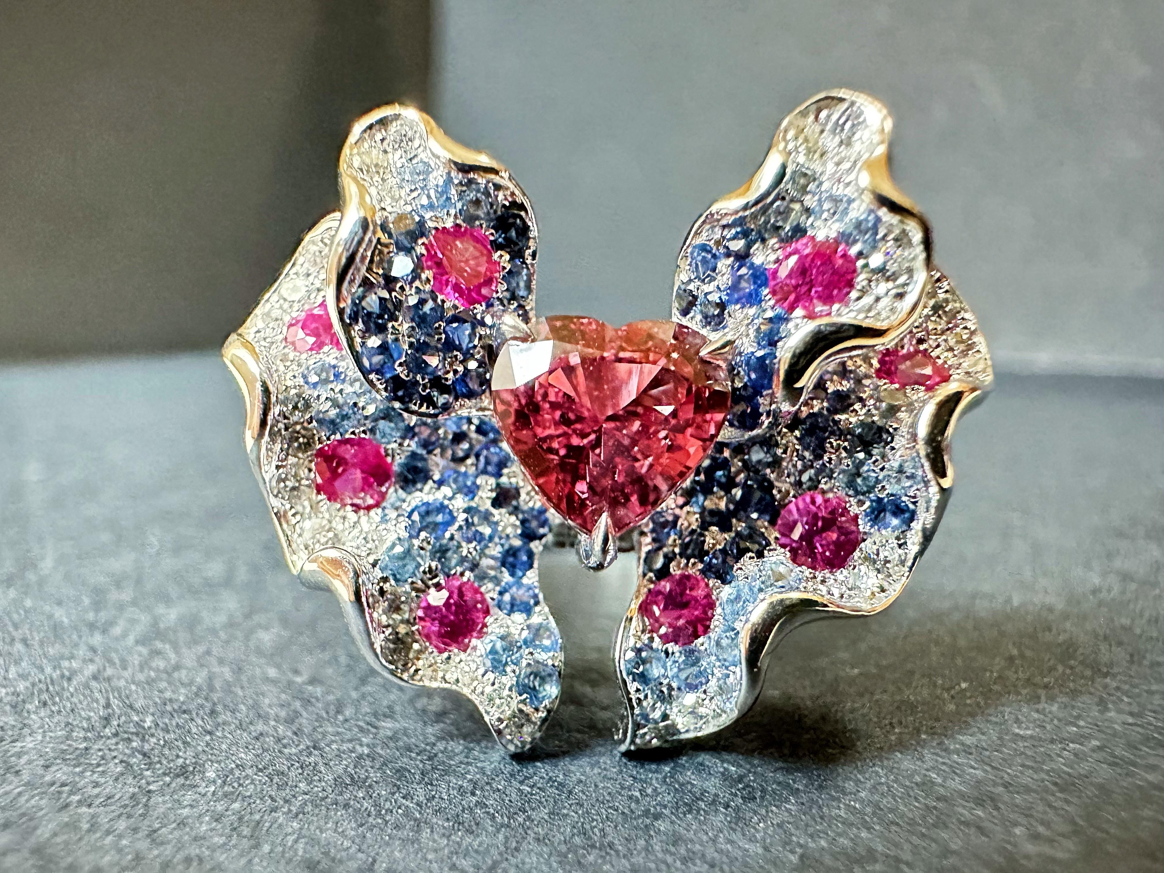 Immerse yourself in timeless elegance with our exquisite diamond pendant cum ring featuring a breathtaking orangish pink padparadscha sapphire in a butterfly design. This one-of-a-kind art piece is expertly handcrafted in 18K white gold, adorned