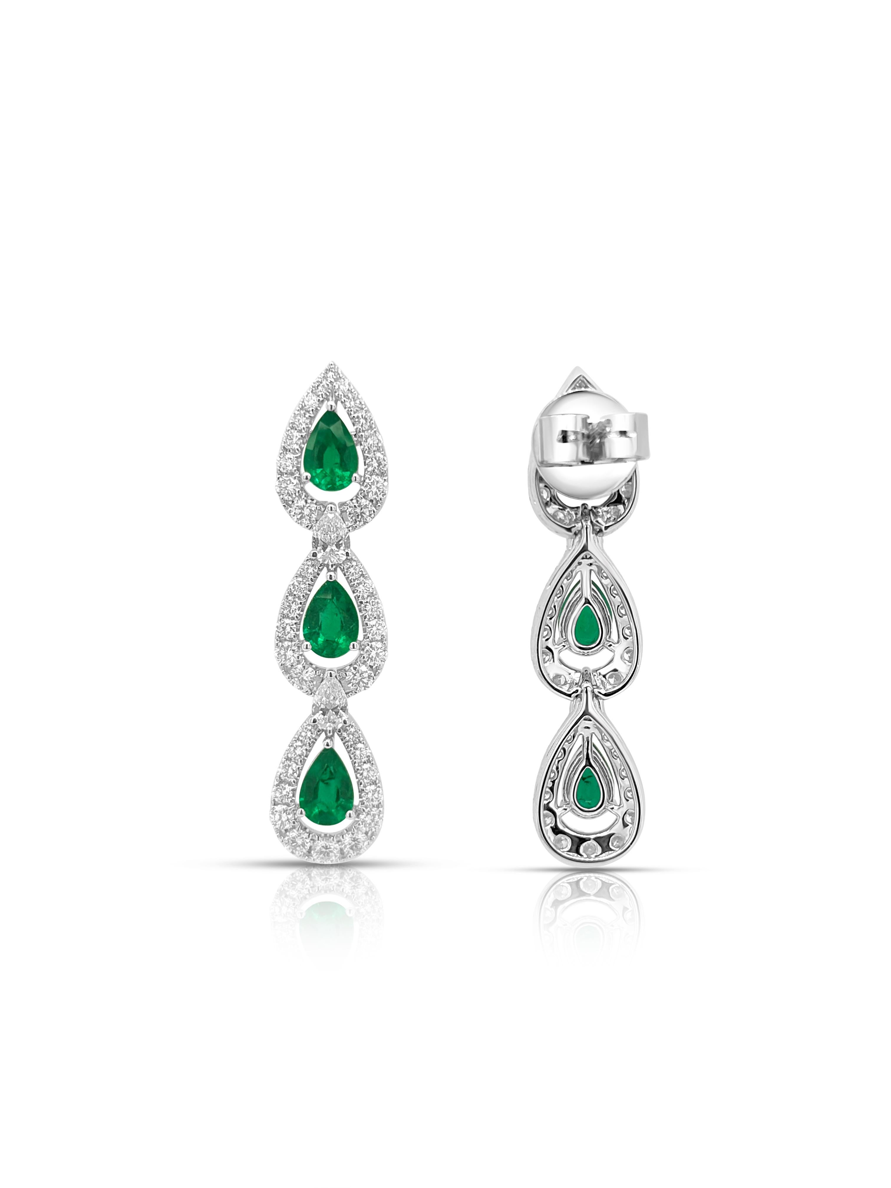 Faites une déclaration éblouissante avec ces boucles d'oreilles de créateur à couper le souffle, mettant en vedette de luxuriantes émeraudes colombiennes associées à une cascade de diamants blancs rayonnants. Le design dynamique et oscillant assure