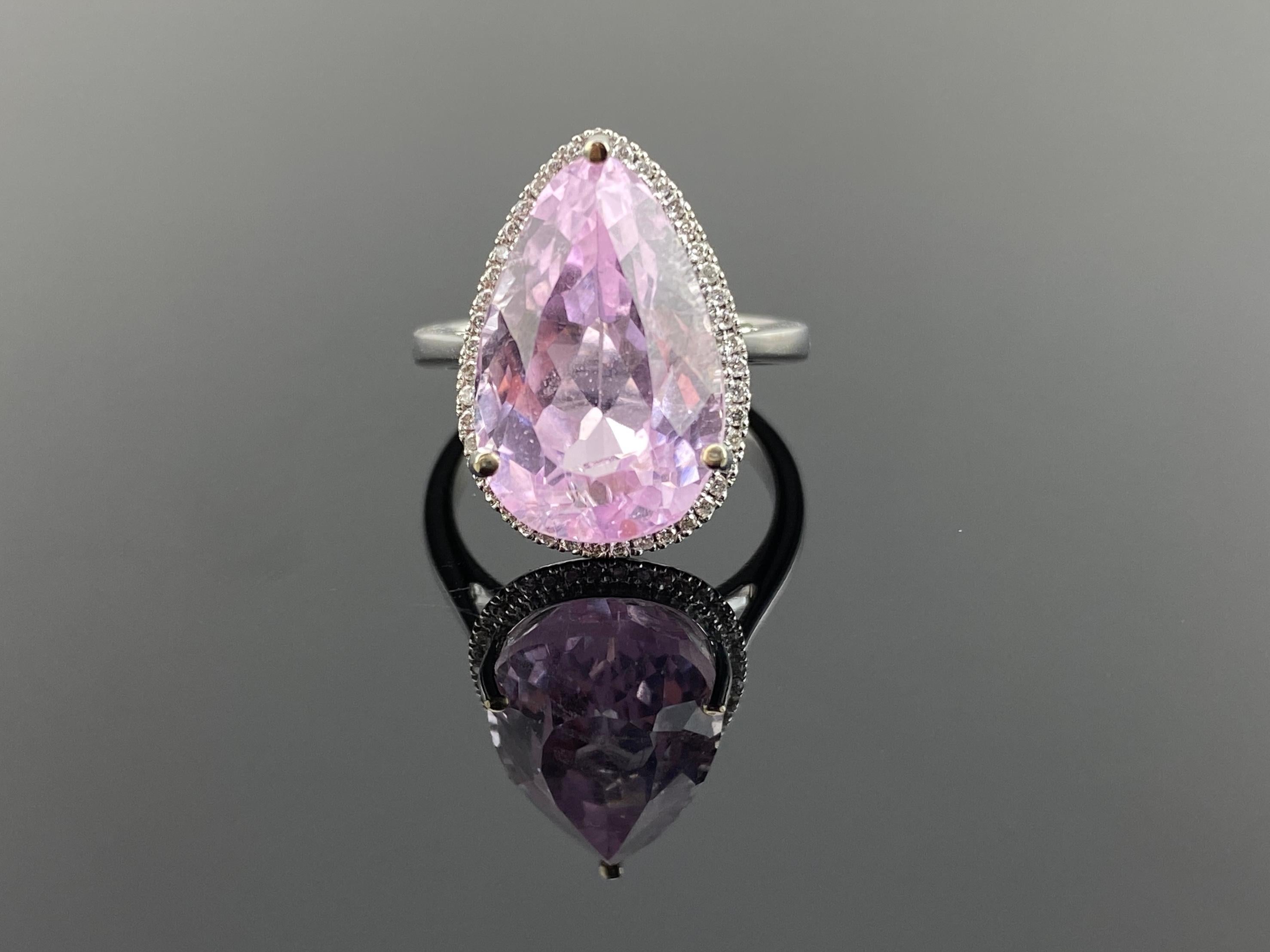 Make a statement with this beautiful 12.12 carat, certified, pear shape Kunzite ring, with 0.26 carat Diamond surrounding it, all set in solid 18K white gold. The Kunzite center stone is 17.2mm x 11mm is dimension, transparent, with a beautiful pink
