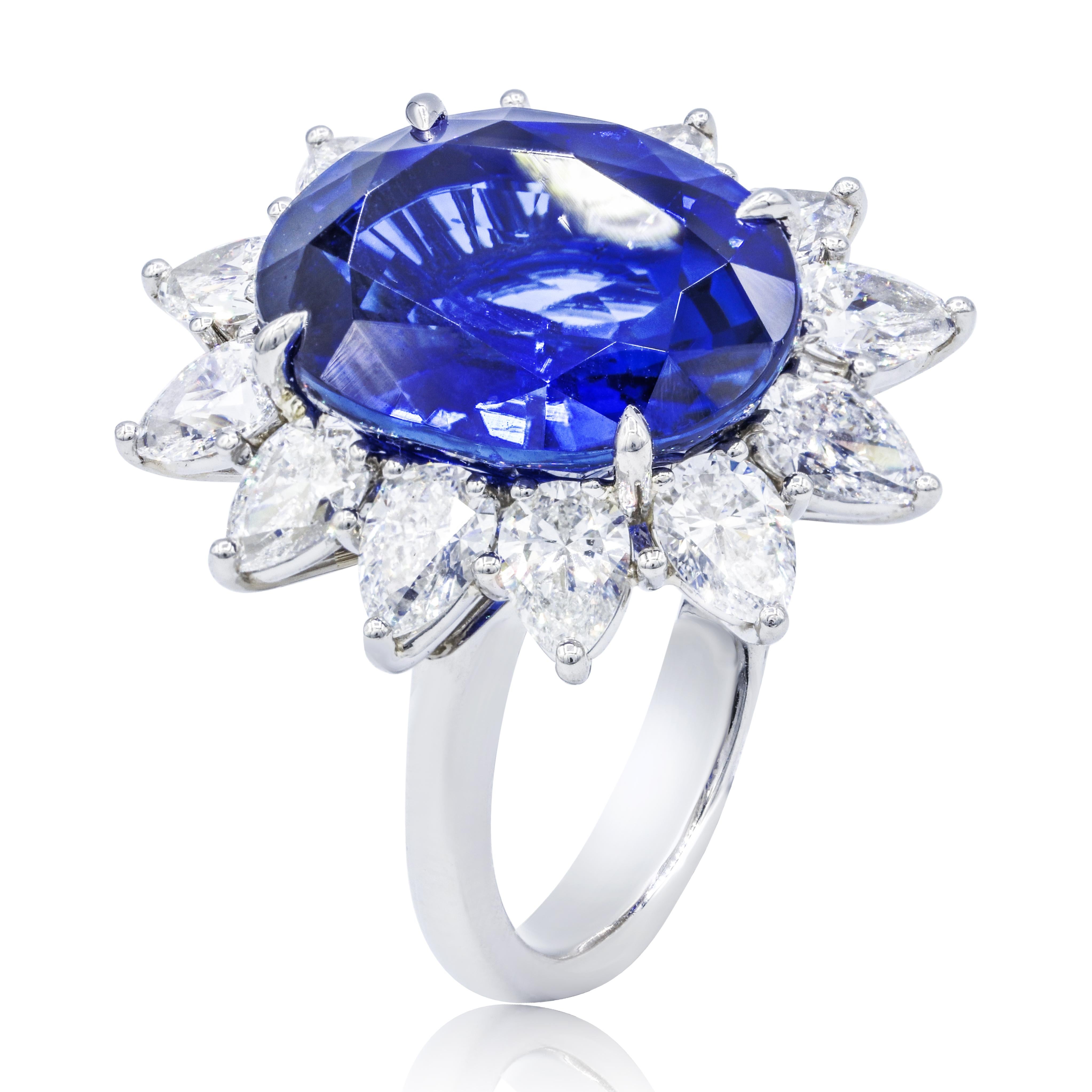 Royal platinum sapphire and diamond ring with C.Dunaigre certified 16.20 carats oval cut ceylon sapphire set with 3.92 carats in a halo with pear shaped diamonds.