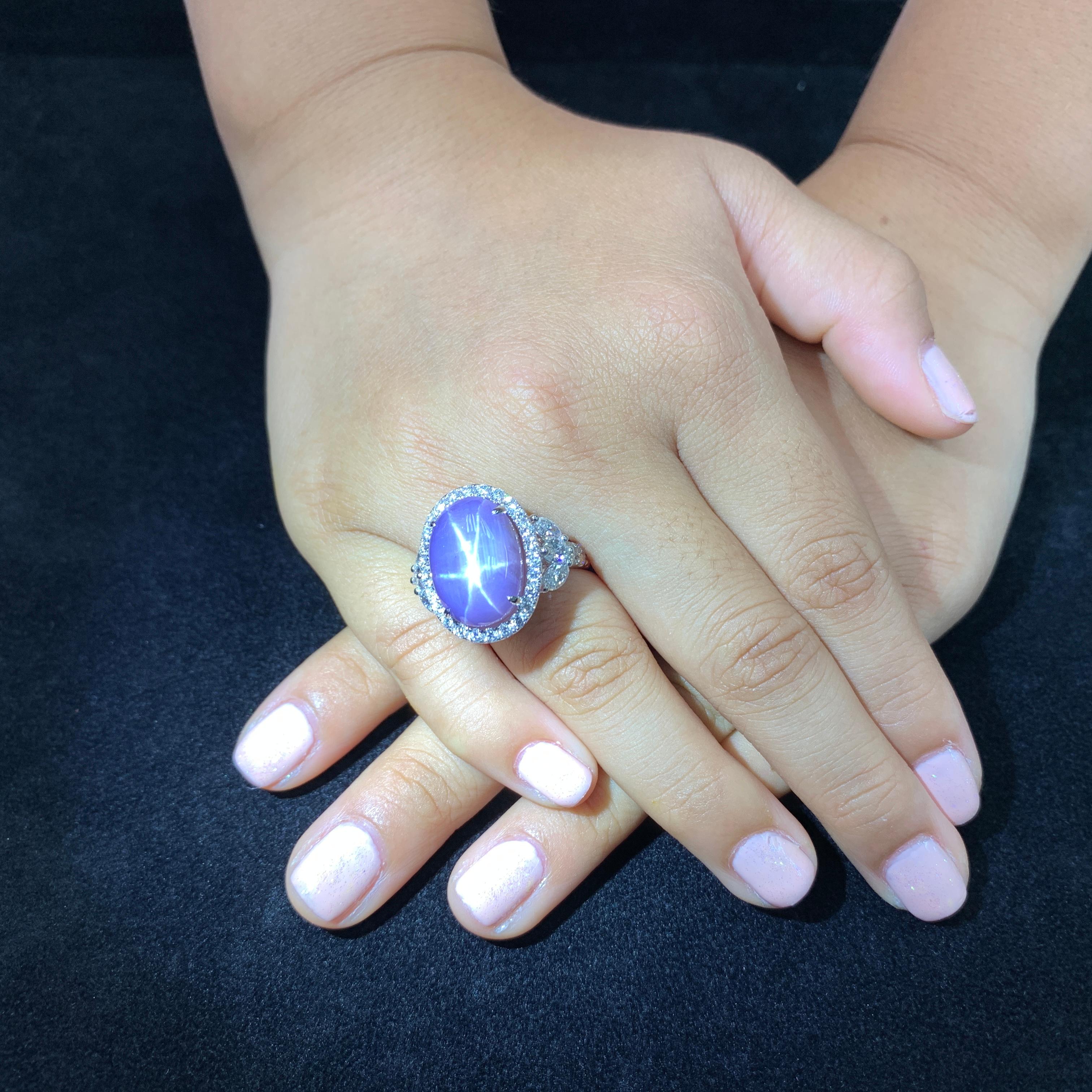 ASK FOR A VIDEO! Super strong star! A statement piece for sure. Here is a certified natural purple star Sapphire and diamond ring. The ring is set in 18k white gold and diamonds. There are combinations of Marquis and round diamonds that make up this