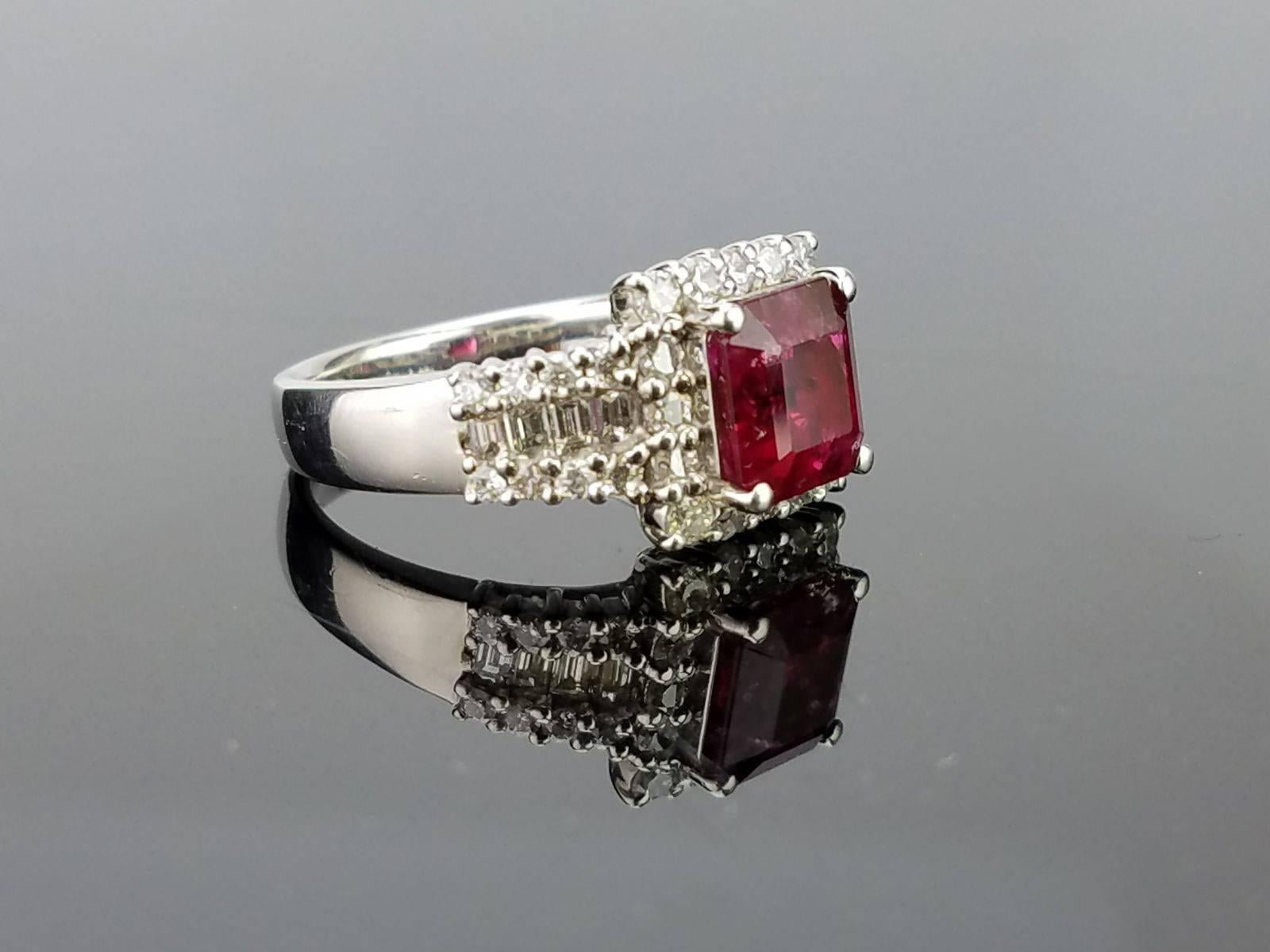 Considered one of the worlds rarest gemstones, an investment piece of extremely rare 1.61 carat red emerald (red beryl) of great lustre, and colour set in platinum with diamonds sorrounding it. 

Stone Details:
Stone: Red Emerald (Red Beryl)
Cut:
