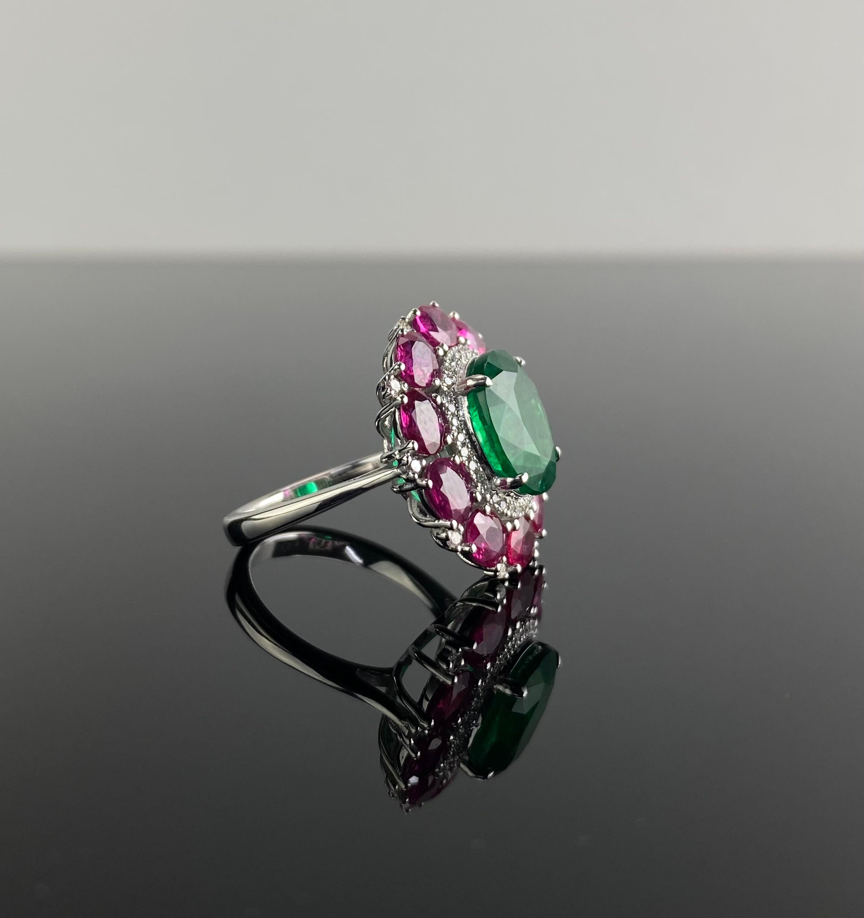 This ring showcases a breathtaking combination of diamonds, rubies, and a vivid Zambian emerald. The center emerald is a natural Zambian emerald, oval-cut, measuring 11.8 x 9.8 mm and weighing 4.64 carats, radiating vibrant green hues.

People have
