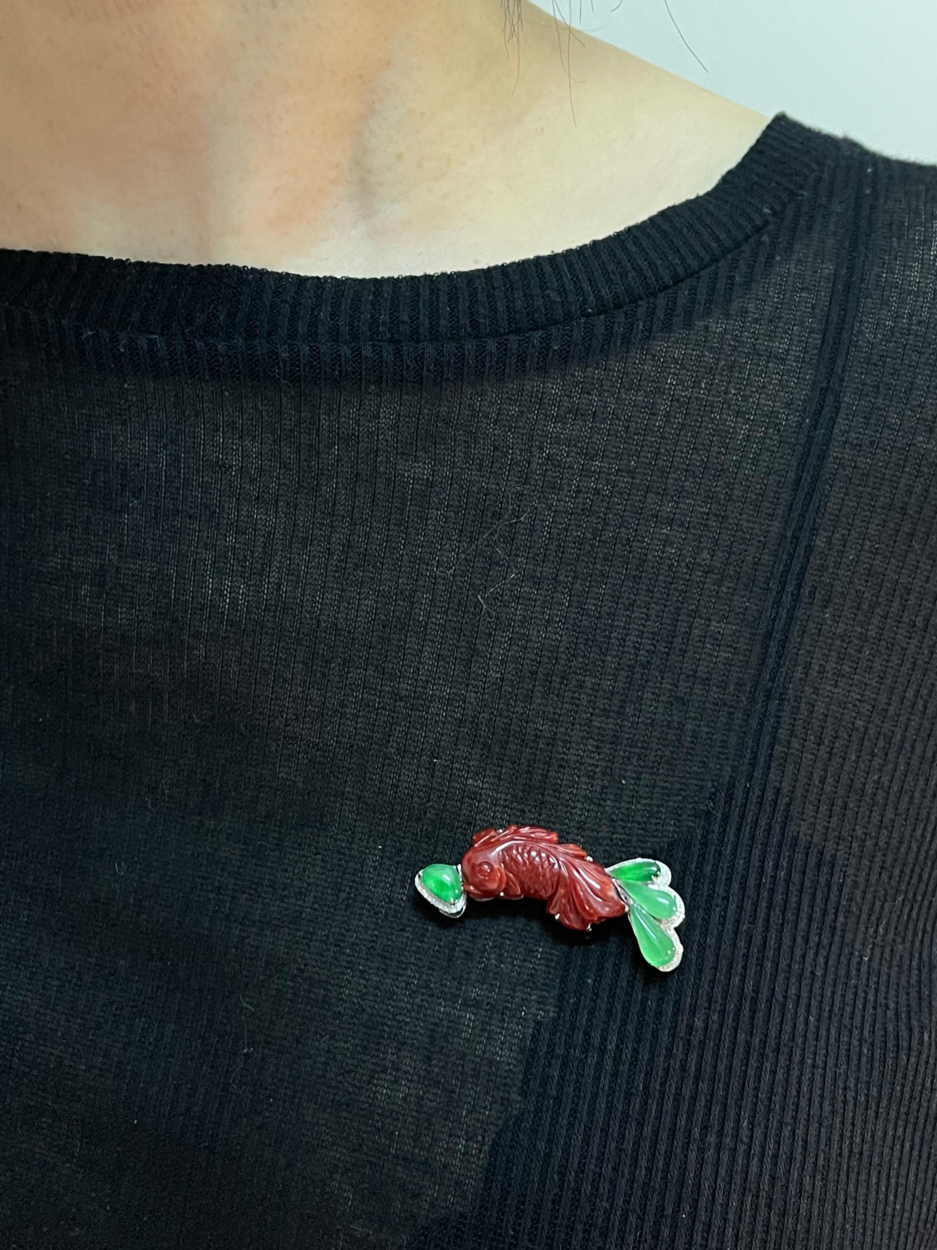 Please check out the HD video! This item can be used as a pendant or a brooch! This is a very well carved natural red coral Koi fish matched with glowing icy apple green jade and diamonds. There are 2 certificates, one for the natural red coral and