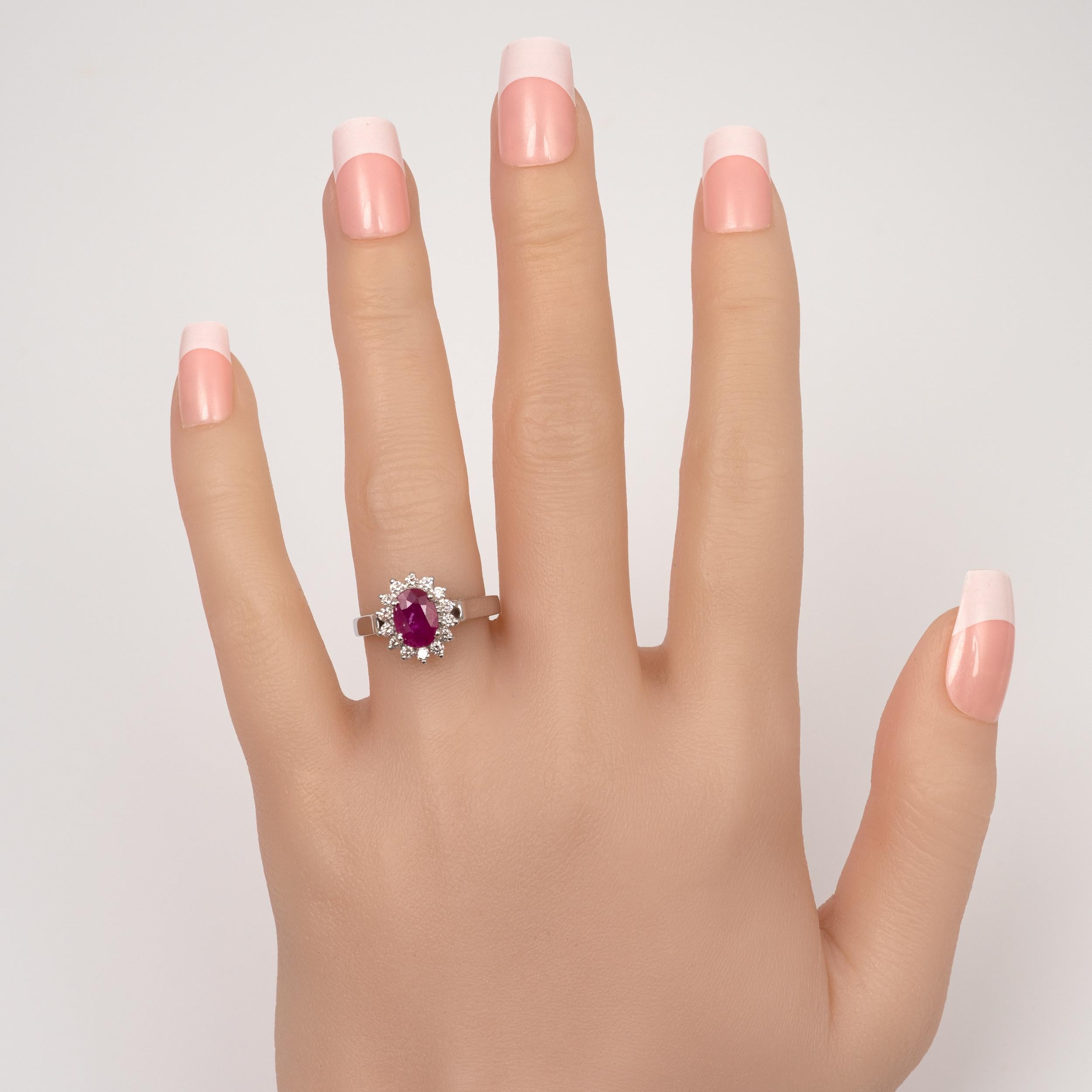 This fine quality oval cut ruby diamond halo ring is crafted in 18 karat white gold.

Featuring an oval-cut natural ruby and complimenting surround of SI-quality round-cut diamonds. The ruby is 4 prong-set and shows natural inclusions.

Crafted by