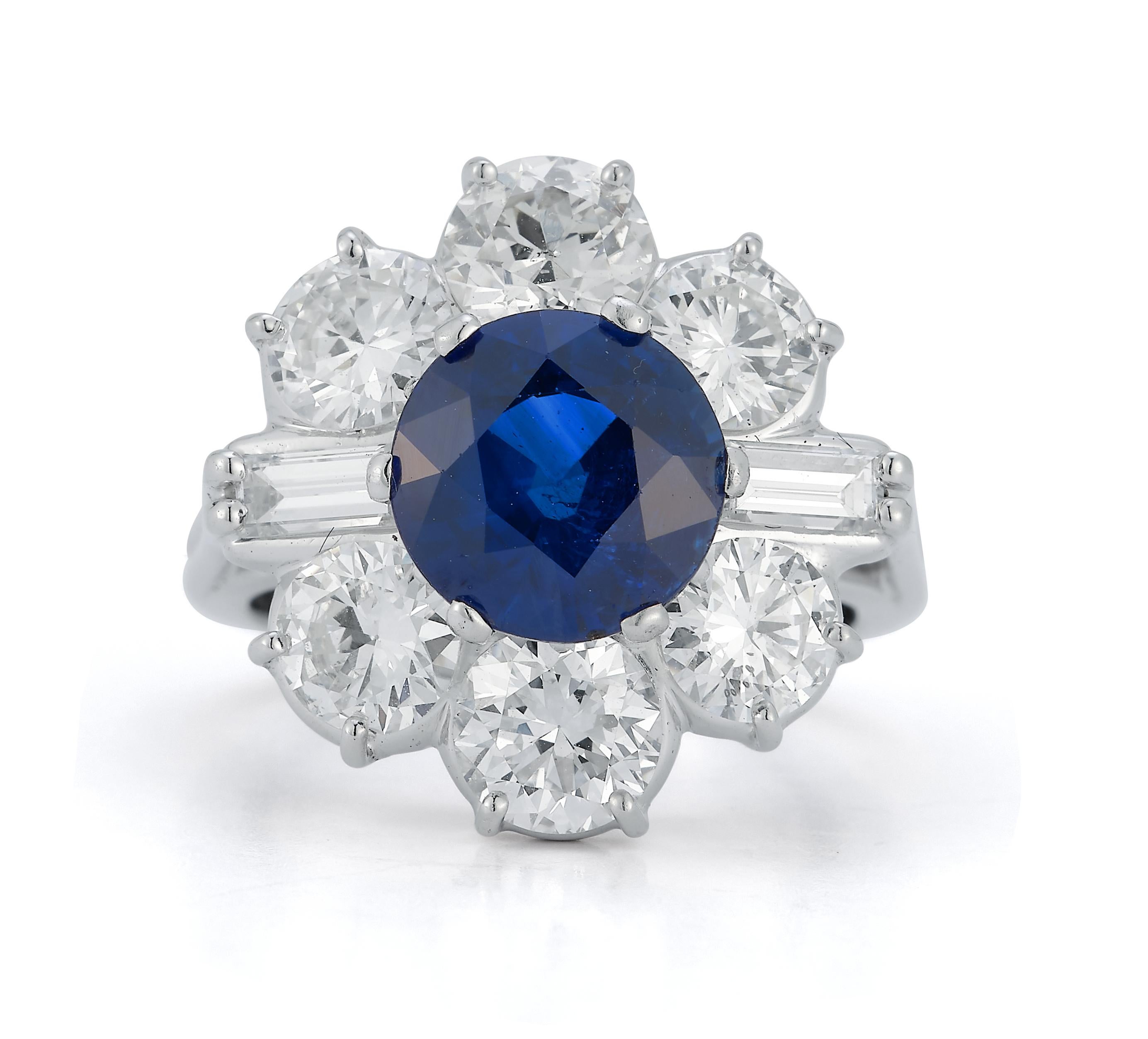 Certified Sapphire & Diamond Flower Ring

 A platinum ring set with a central round cut heated sapphire framed by 6 European & 2 baguette diamonds in the shape of a flower

Sapphire Origin: Thailand
Sapphire Weight: 3.48ct

Diamonds total