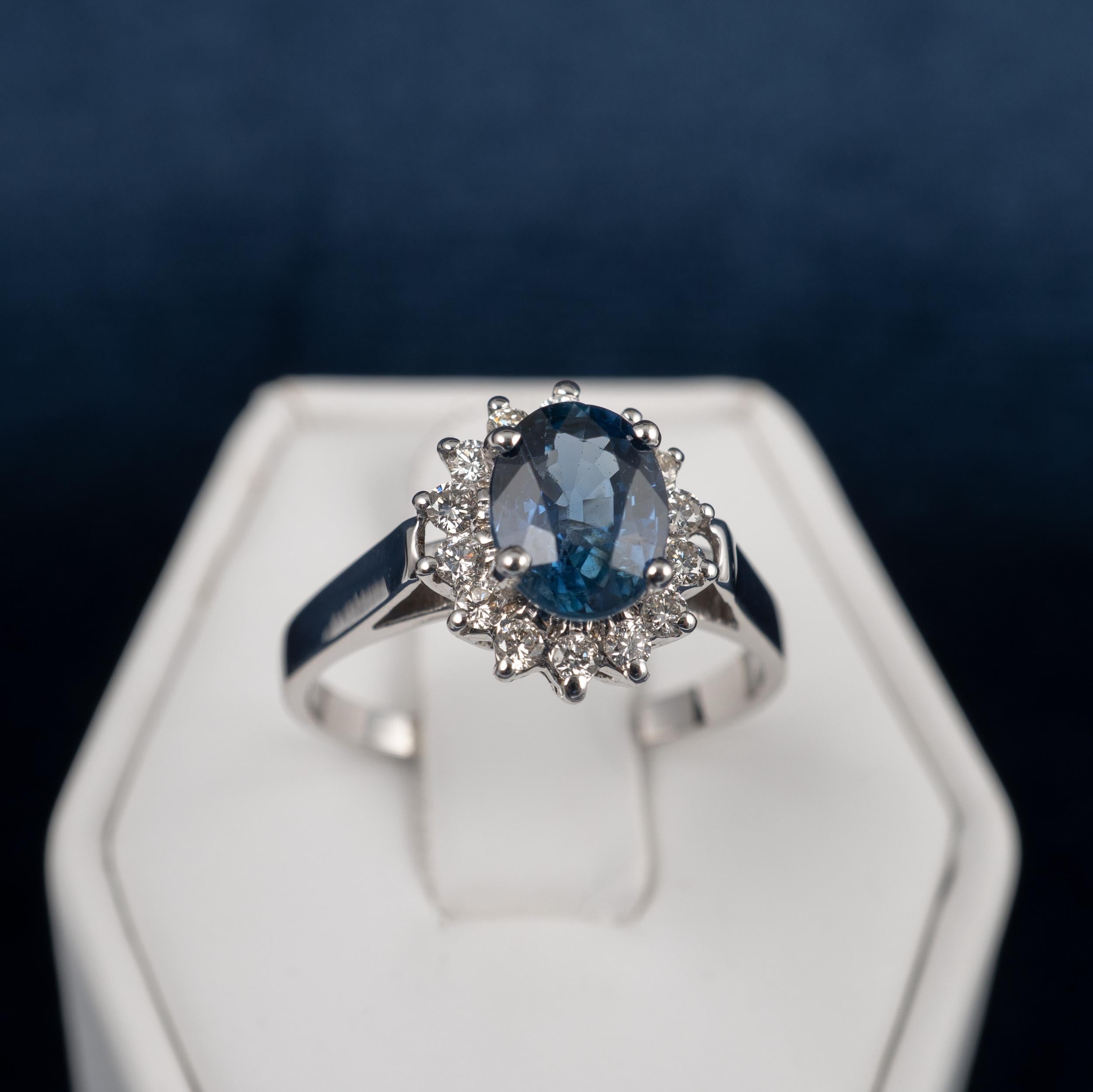 A fine quality sapphire diamond halo dress ring in 18 karat white gold.

This contemporary ring expertly crafted. It displays full British assay hallmarks and comes with gemstone certification and a neat leatherette gift ring box for the perfect