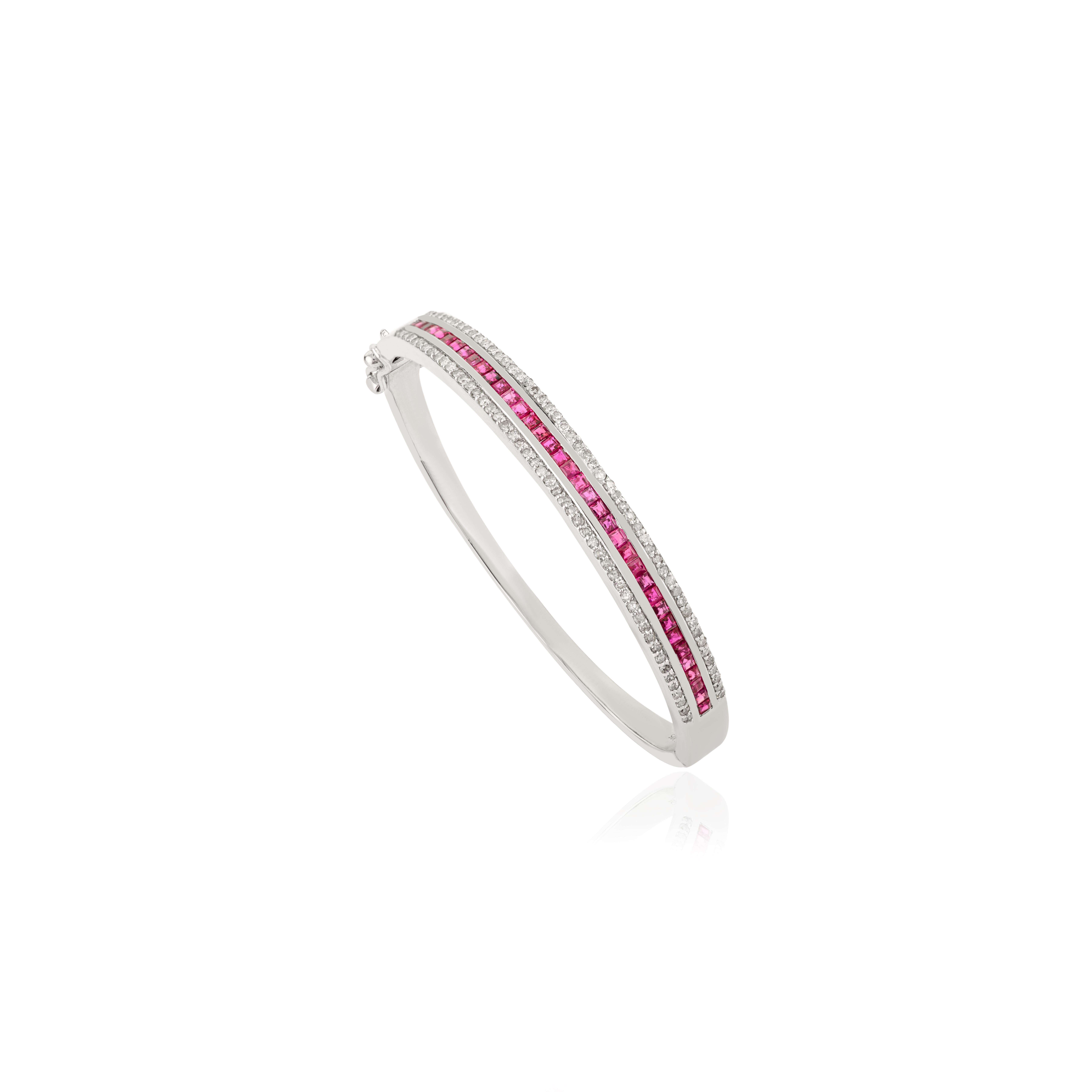 Elegant 925 sterling silver bangle bracelet featuring 1.75 carats of natural rubies channel-set at the center, framed by 1 carat of sparkling diamonds. The sleek design blends vivid red brilliance with diamond shimmer, creating a timeless piece,
