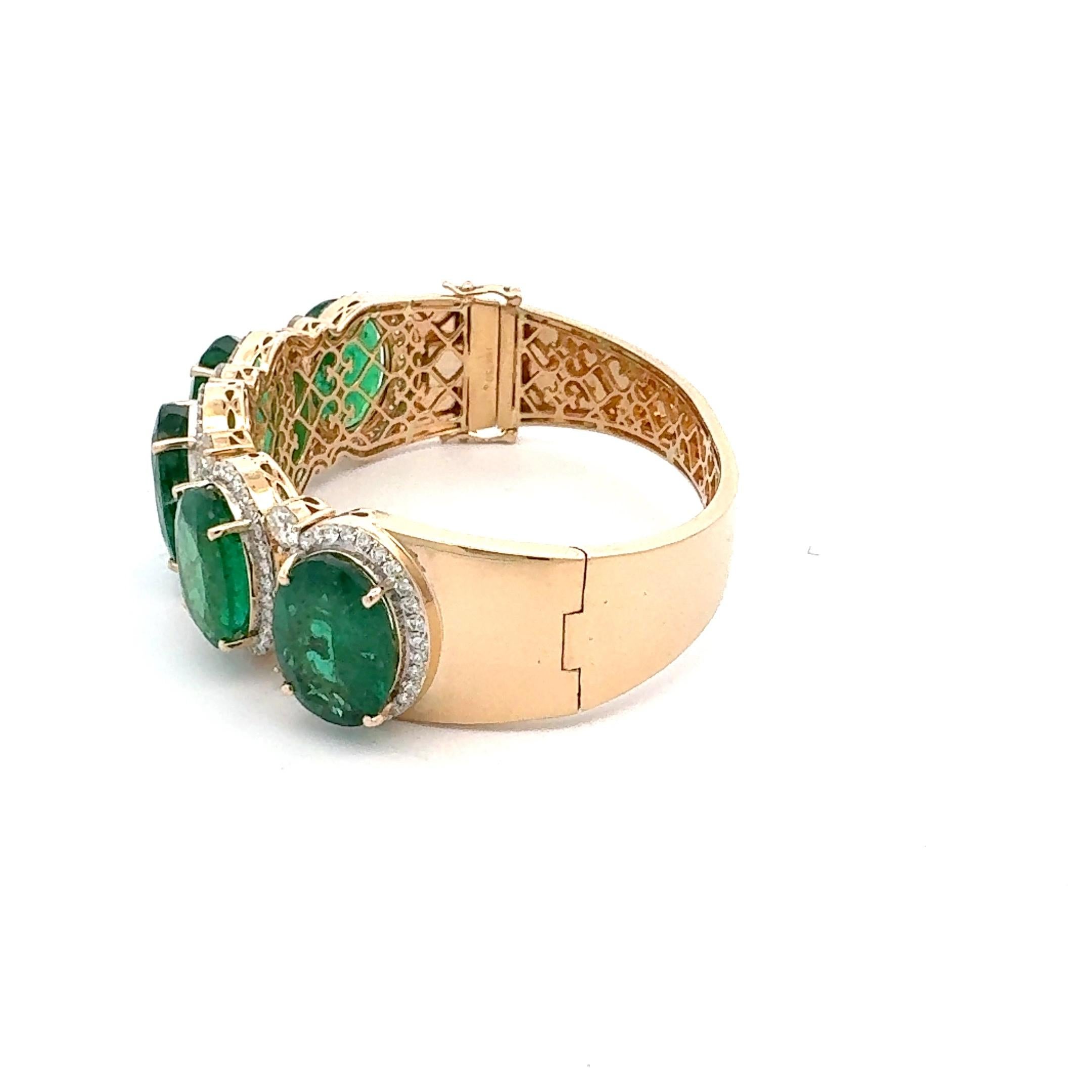 Oval shaped Zambian emeralds set in an intricately designed 18karat yellow gold. The combination of the vibrant green Zambian emerald and sparkling accents with diamonds make it a truly exquisite piece to your collection, perfect for any occasion.