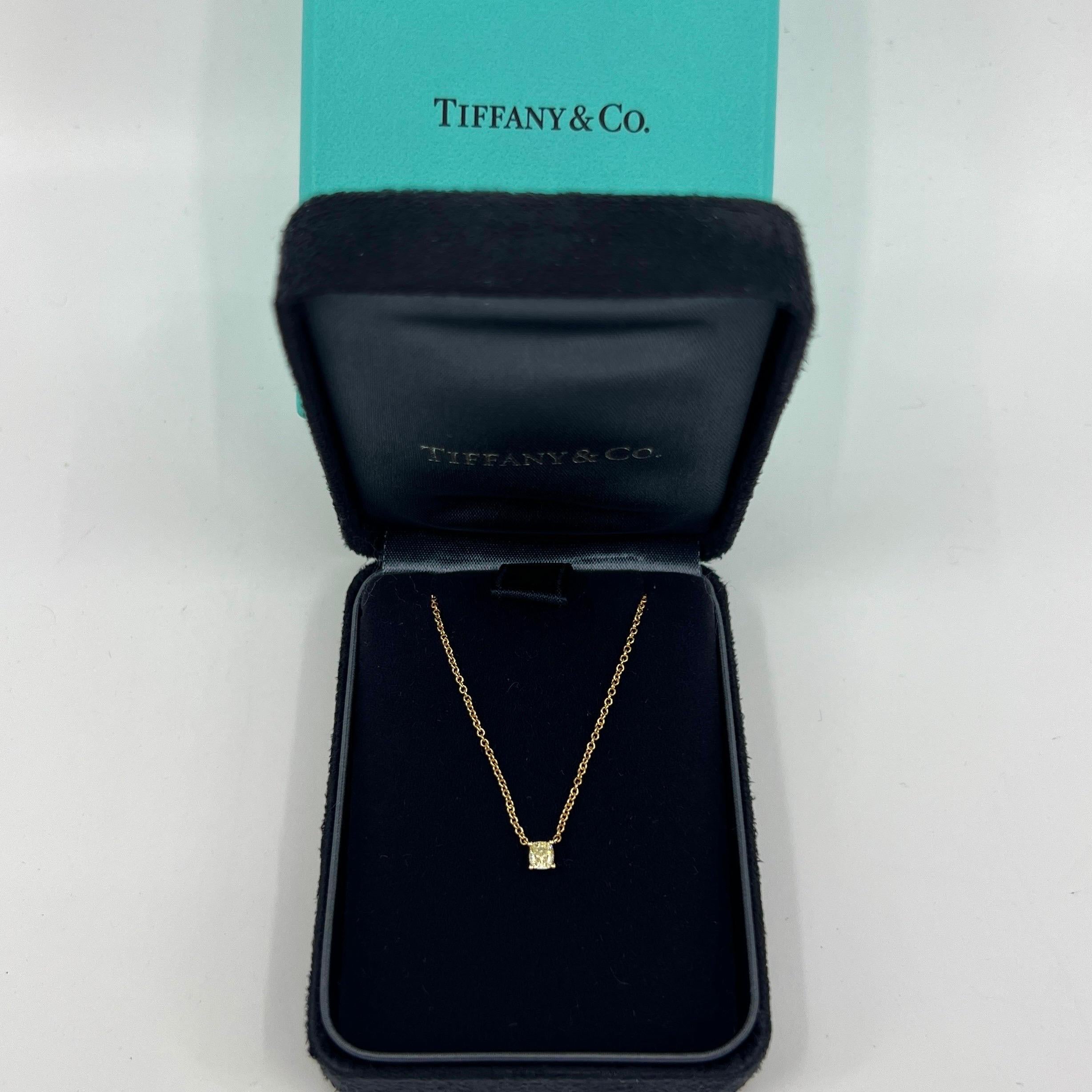 Fine Vintage Tiffany & Co. Fancy Yellow Diamond 18k Gold Solitaire Pendant Necklace.

A beautiful classic solitaire pendant set with a stunning 0.21ct fancy yellow cushion cut diamond. Please see report for diamond size.
This diamond has a full