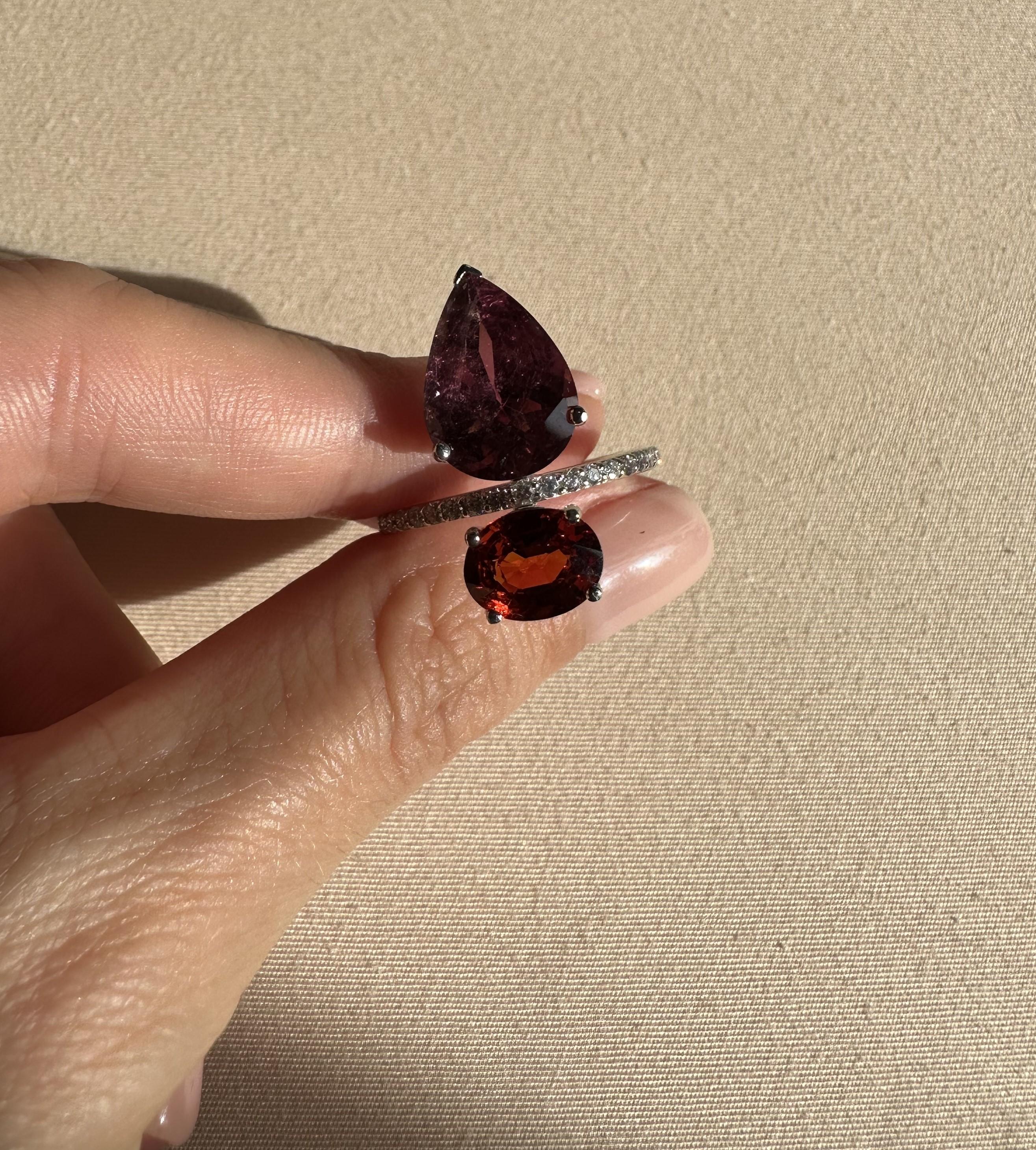 A beautiful cocktail ring, with natural Mozambique Tourmaline weighing 4.37 carats, and natural Spessartite weighing 2.39 carts, and 0.3 carat White Diamonds. The design of this ring is modern, with 2 beautifully contrasting natural gemstones. The