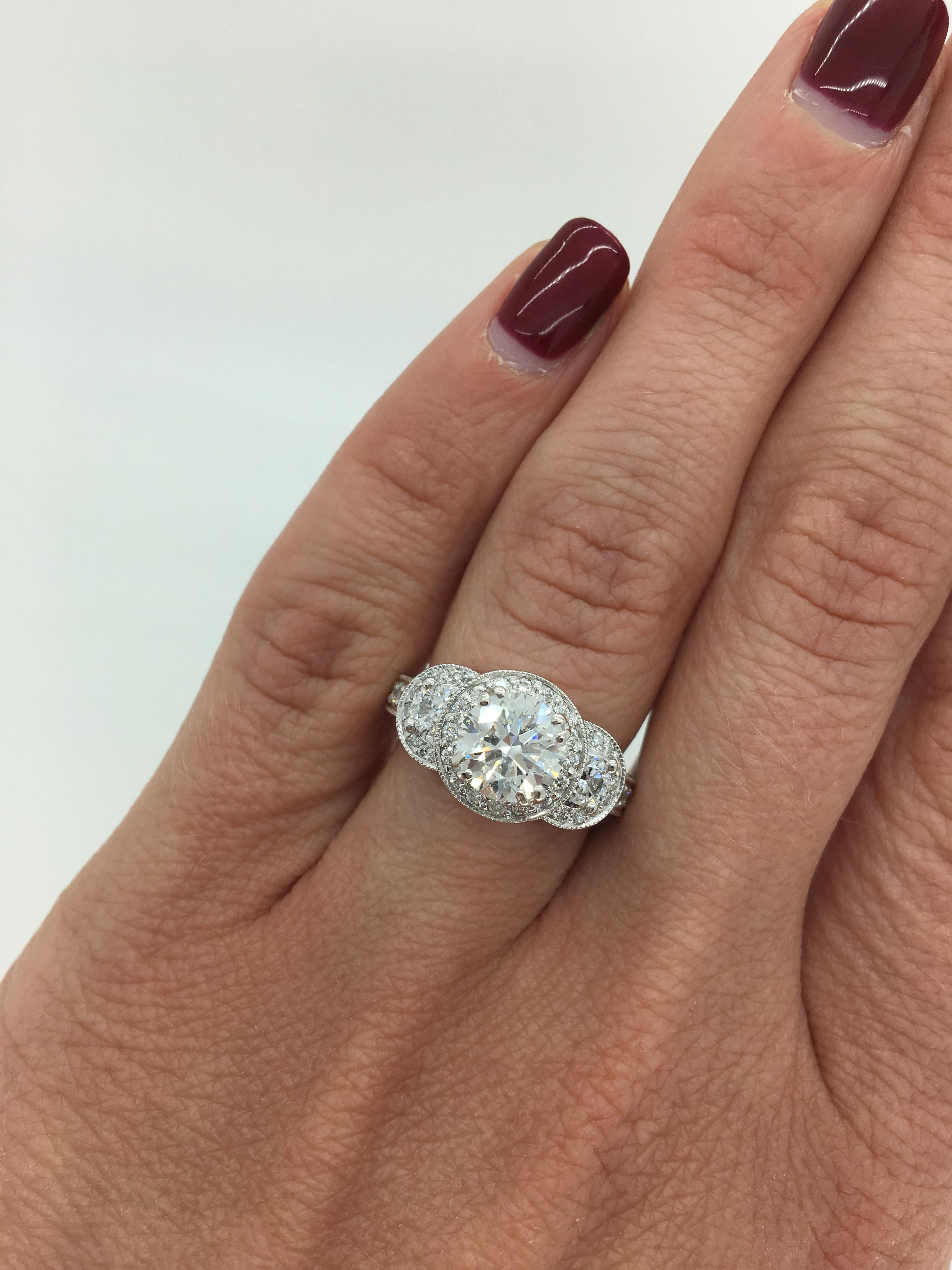 This stunning 18k white gold engagement ring features an EGL Certified 1.33CT Tolkowsky Ideal Round Cut Diamond with F color and SI2 clarity per EGL certificate. Graded to GIA Standards the featured diamond displays G-H color and I1 clarity. There