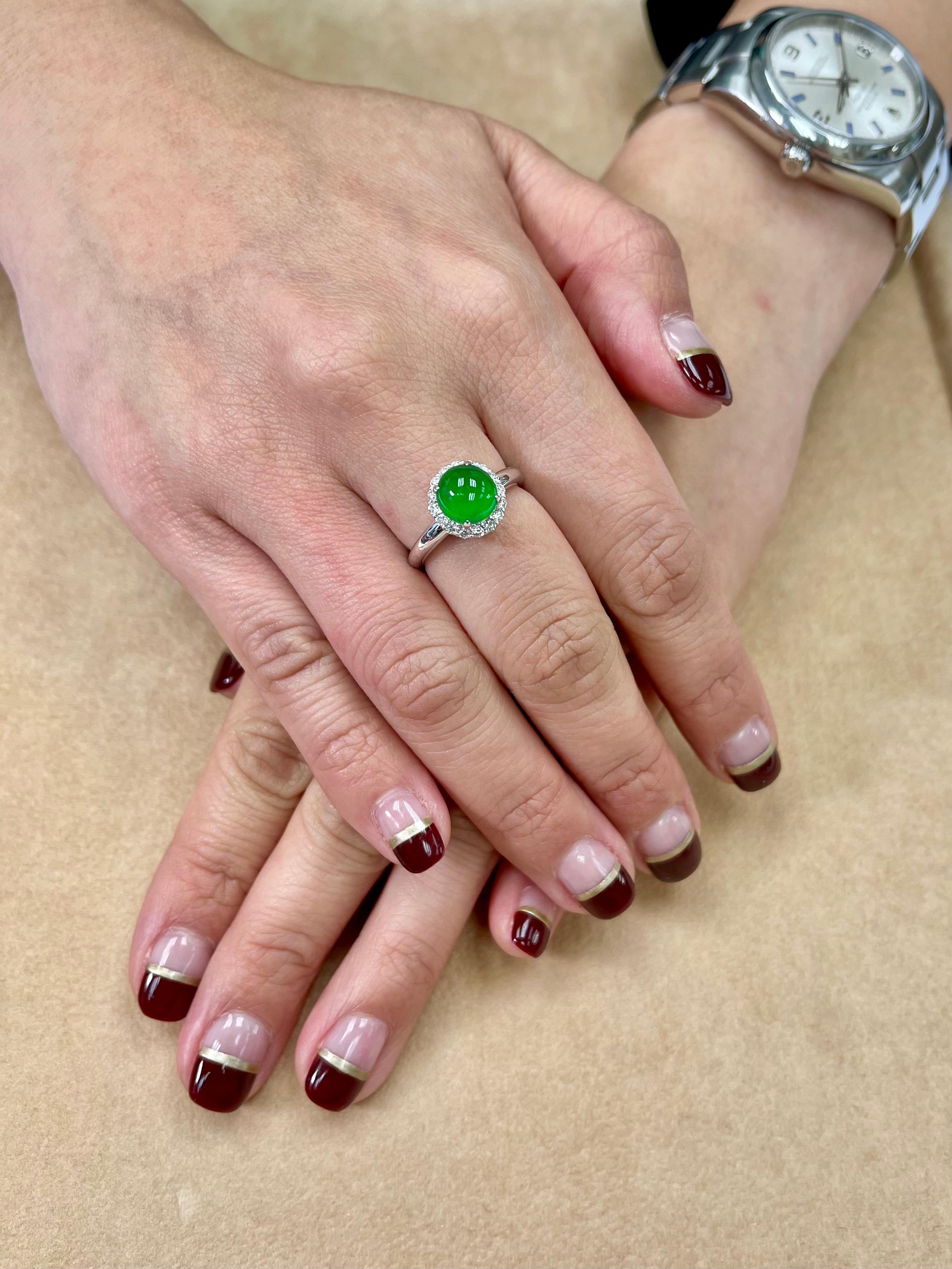 THIS JADE GLOWS! Here is super bright apple green round high domed cabochon jade and diamond ring. It is certified by 2 labs as natural jadeite jade with no treatment or enhancement. The ring is set in 18k white gold and diamonds. There are round