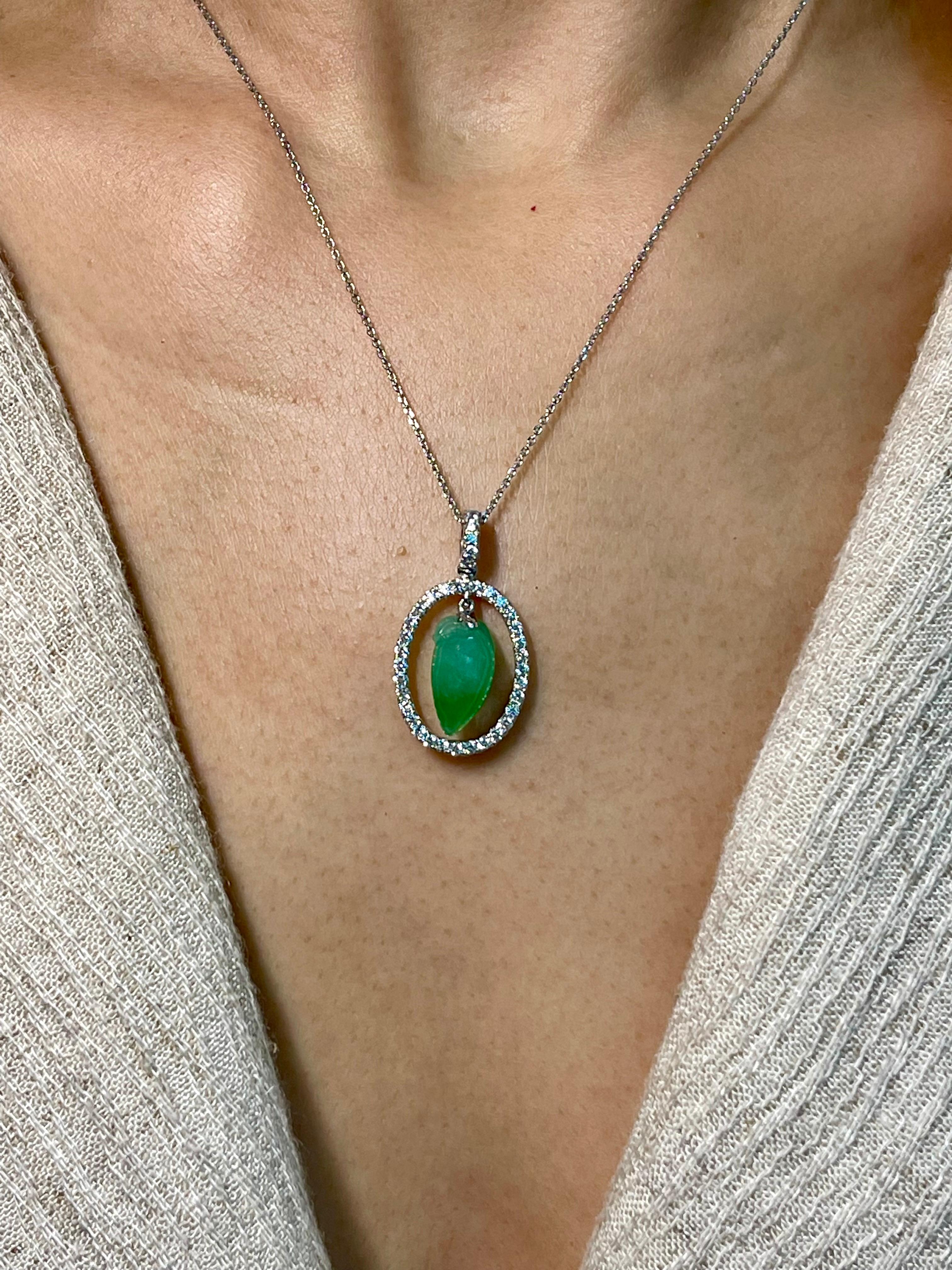 This jade has a beautiful balance of color saturation and transparency! Here is a natural apple green Jade and diamond pendant. It is certified. The pendant is set in 18k white gold and diamonds. There are 0.42 cts of small round diamonds that