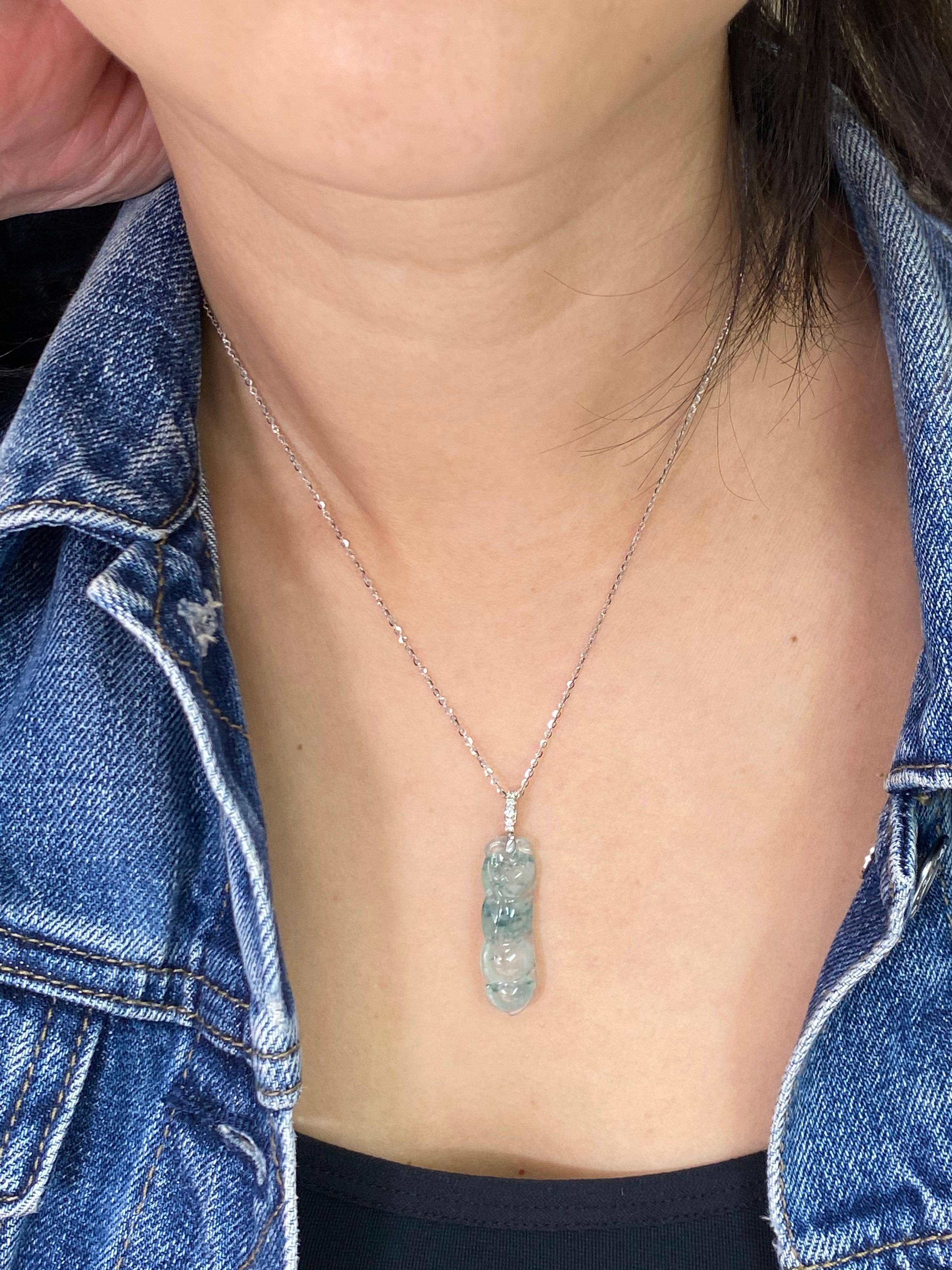 This icy jade pendant are certified by 2 labs. Here is a nice icy Jadeite Jade peapod with green veins running through it . The pendant is about 4 cm long and 1 cm wide. The pendant is set in 18k white gold, and white diamonds. The icy jade peapod