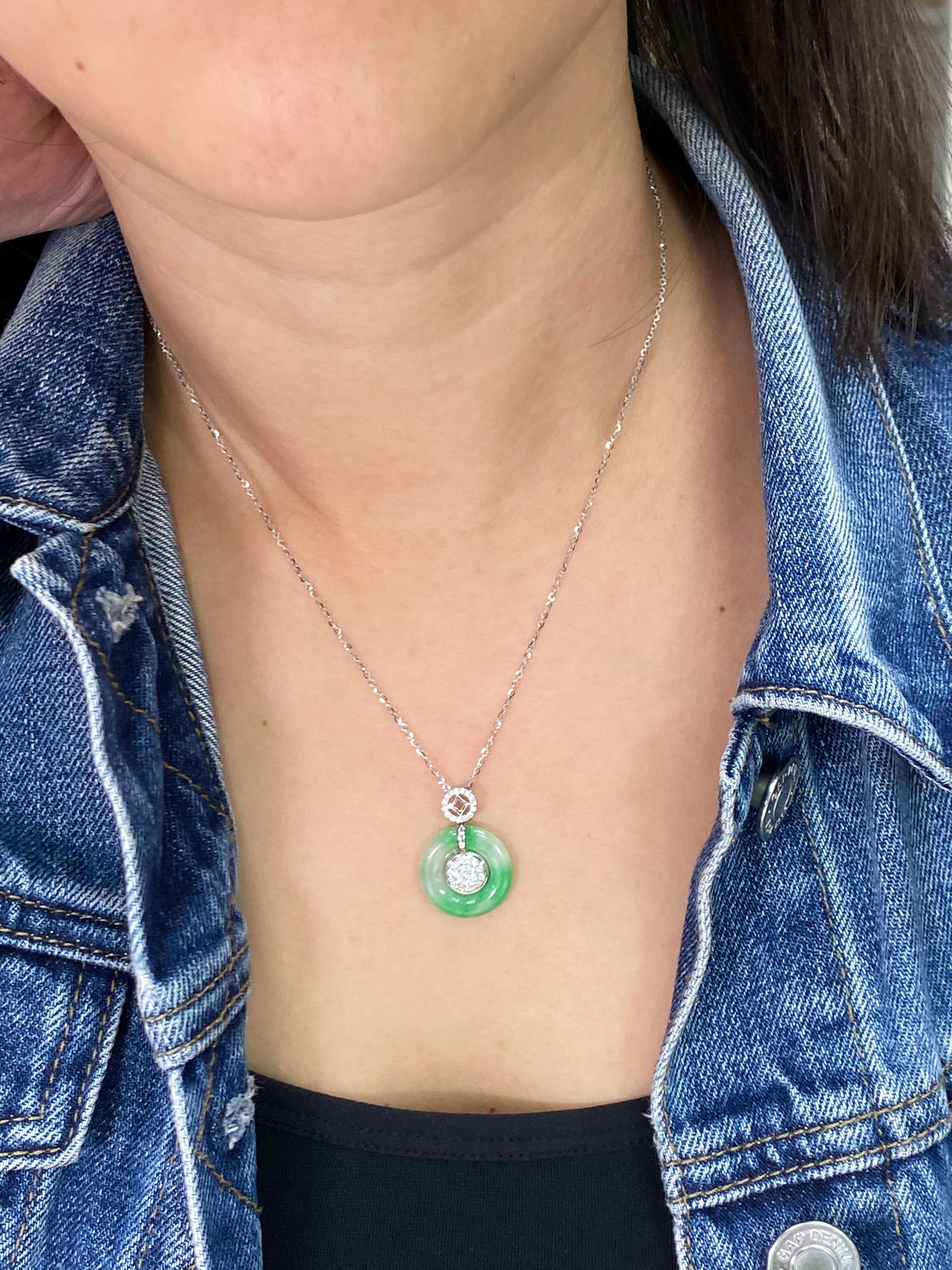 Here is a natural Jadeite Jade and diamond pendant with excellent apple green patches covering around 50% of the jade. It is certified by 2 labs. The pendant is set in 18k white gold and diamonds. The pendant is reversible. On one side the inner