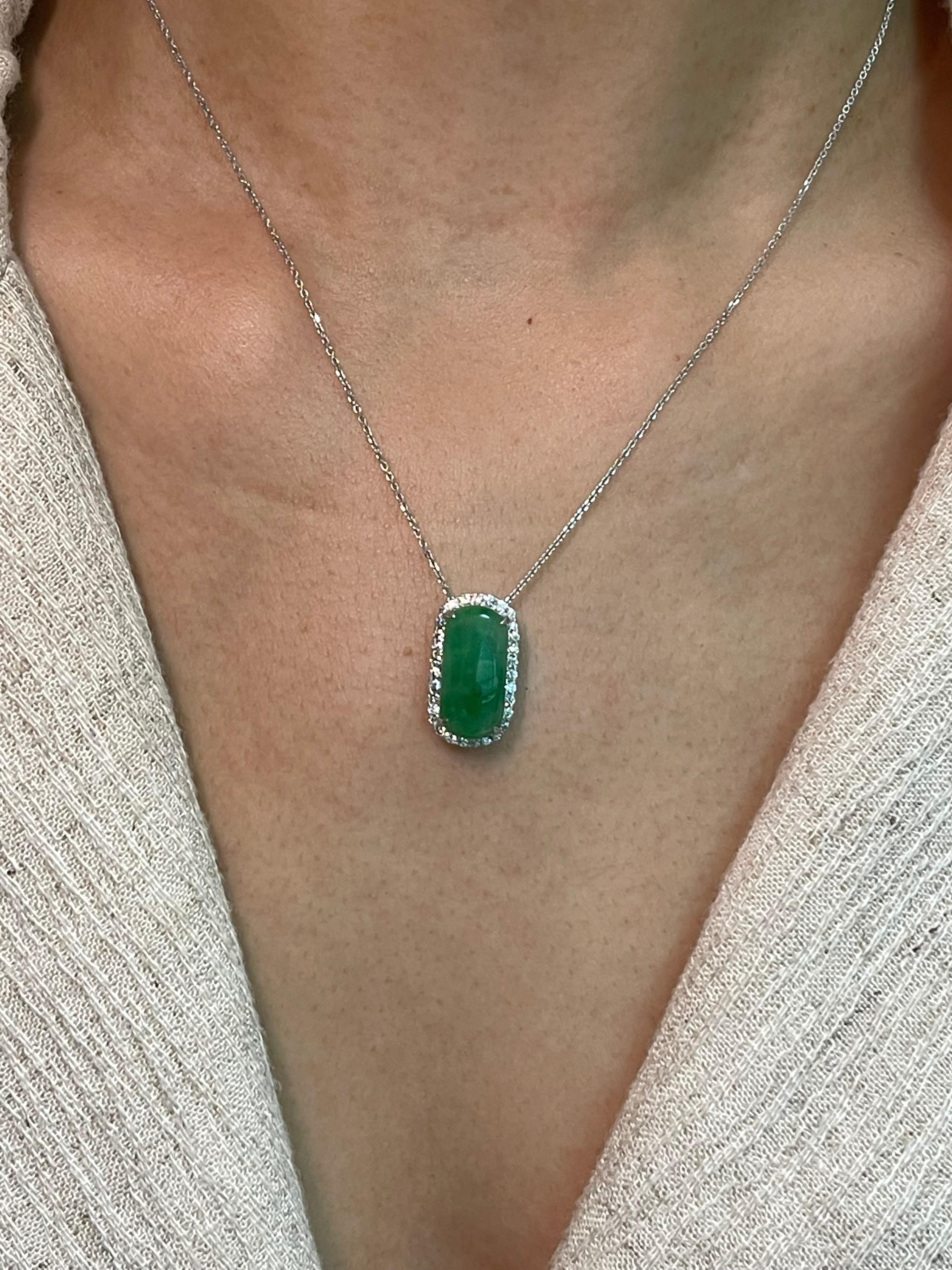 Here is a natural apple green Jade and diamond pendant. It is certified. The pendant is set in 18k white gold and diamonds. There are 0.30 cts of small round diamonds that surrounds the apple green jade. The untreated / unenhanced natural jade is