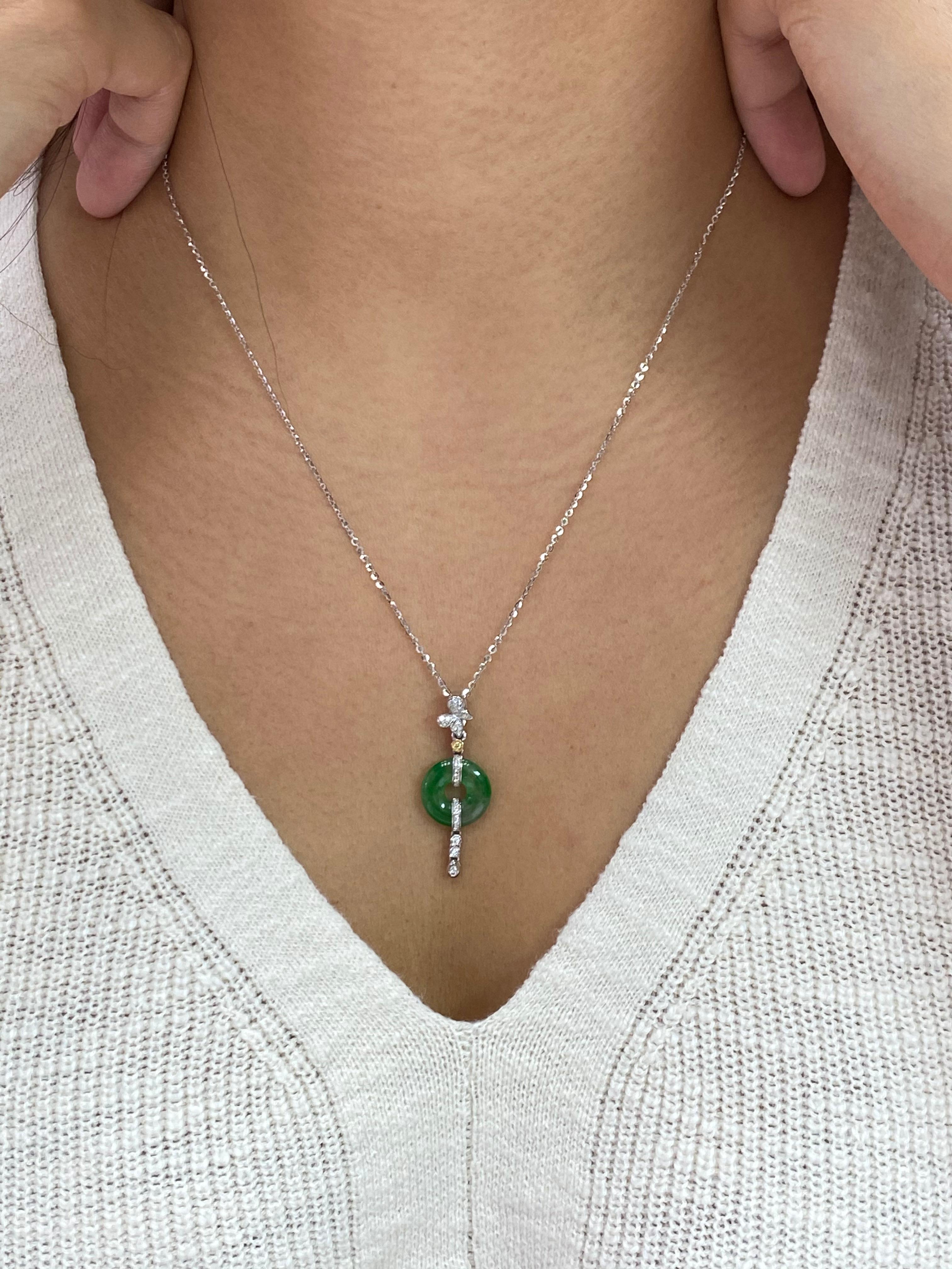 Here is a natural Jadeite Jade and diamond pendant with excellent apple green veins running through the whole piece. It is certified by 2 different labs. The pendant is set in 18k white gold and diamonds. There are diamonds totaling about 0.10 cts