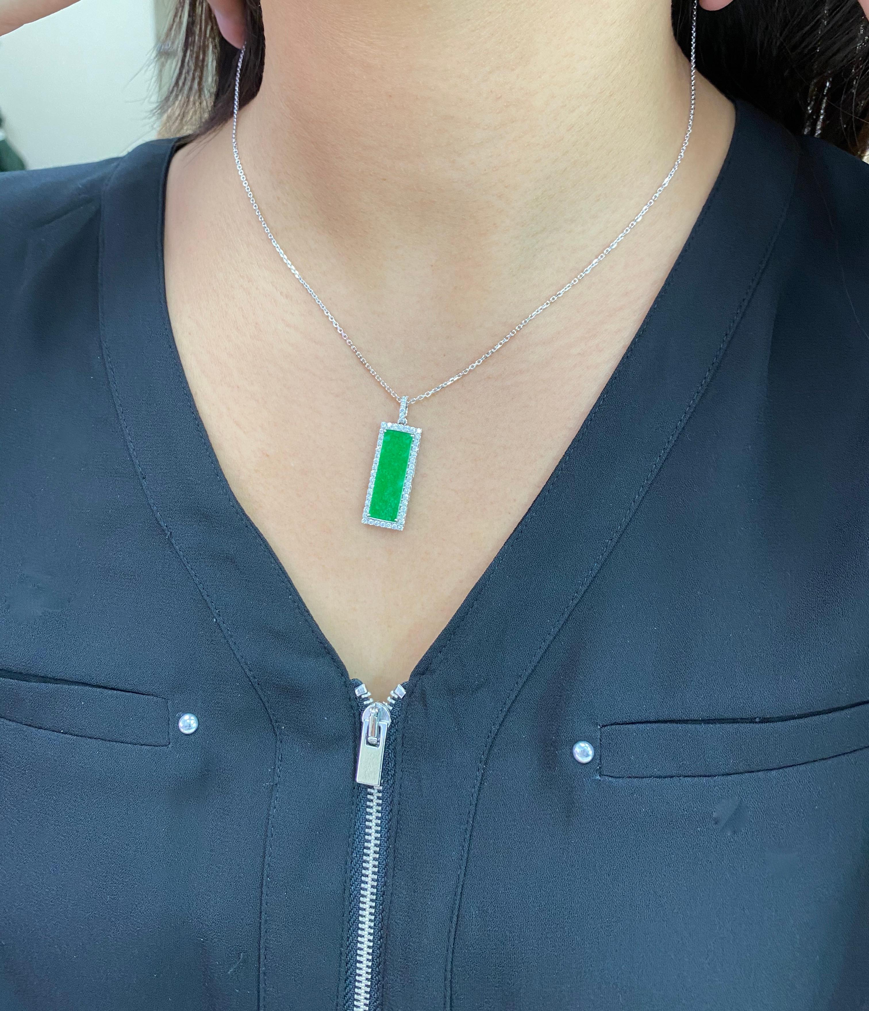 Here is a natural apple green Jade and diamond pendant. It is certified. The pendant is set in 18k white gold and diamonds. On the reverse, is a patterned motif that is hand engraved by a master goldsmith. There are approximately 1 cts of small