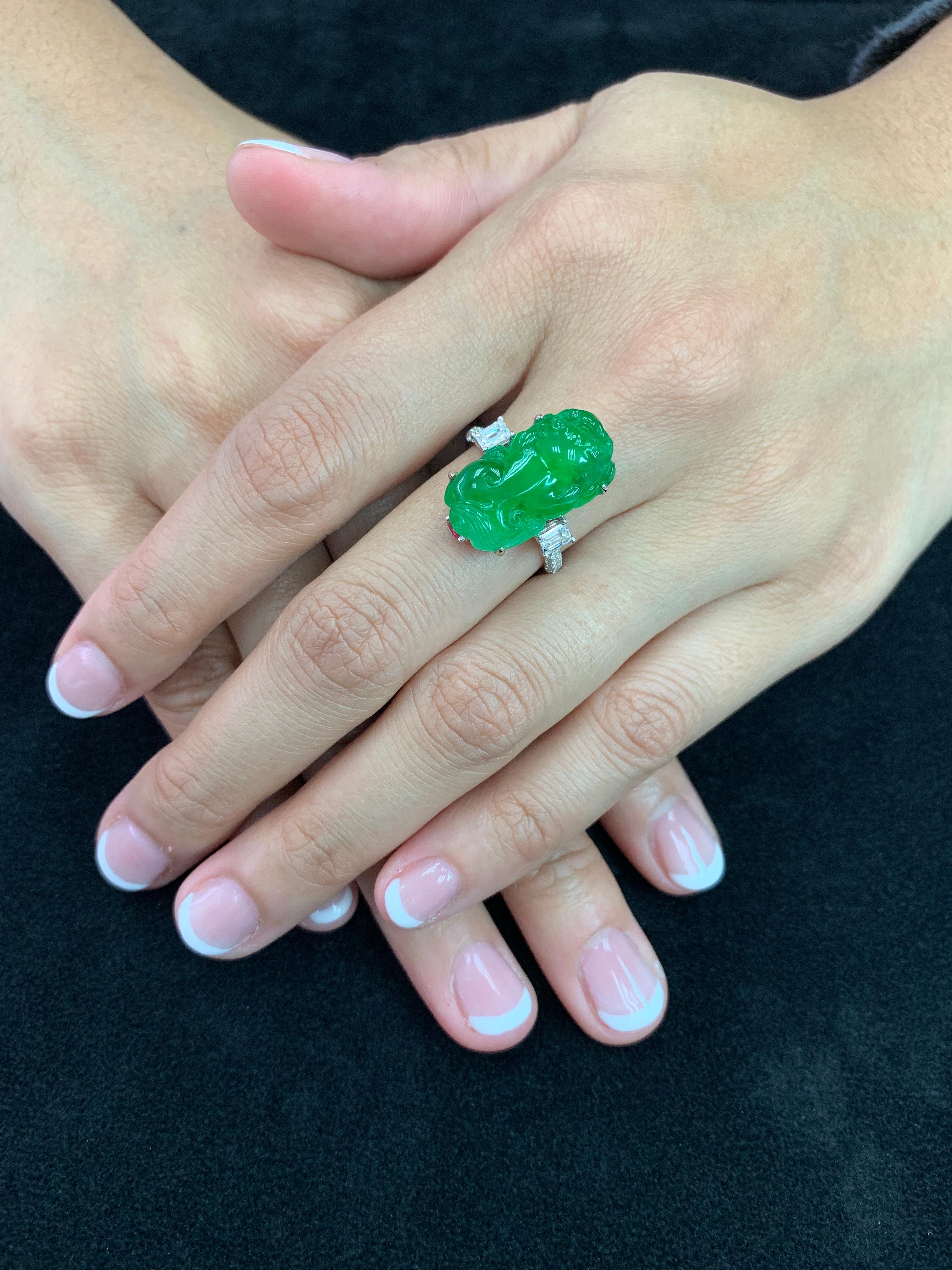 Here is a super vivid green Jade, Spinel and diamond ring. It is certified. The Jade ring is set in 18k white gold, Spinel and diamonds. There are two emerald cut diamonds on each side of the jade totaling 0.78Cts and also small diamonds on the