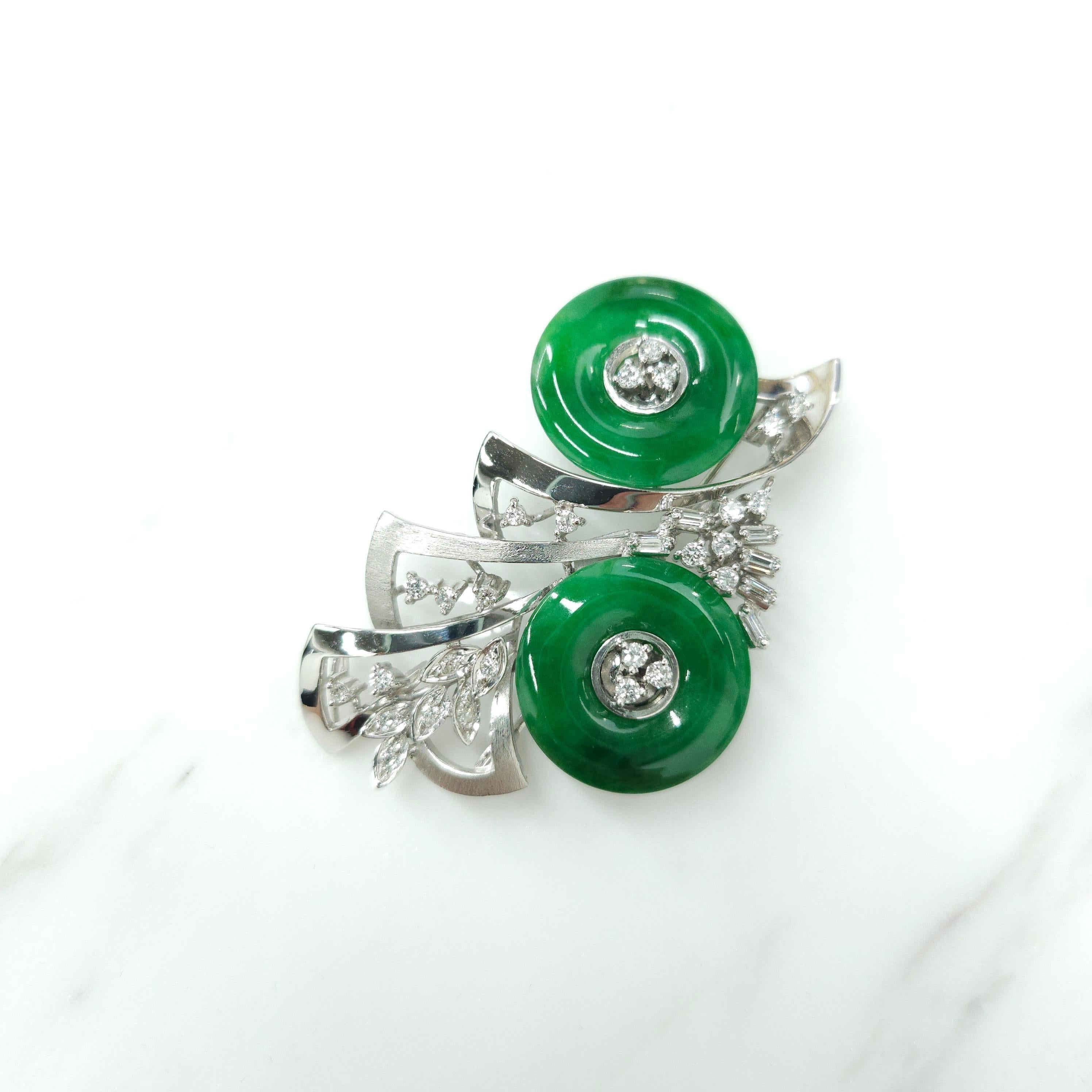 Elevate your accessory game with this one-of-a-kind white gold brooch featuring two pieces of Certified natural A grade Jade (Fei sui) in an intense green color and unique huaigu shape, making it a true treasure to behold. The vibrant green hue of