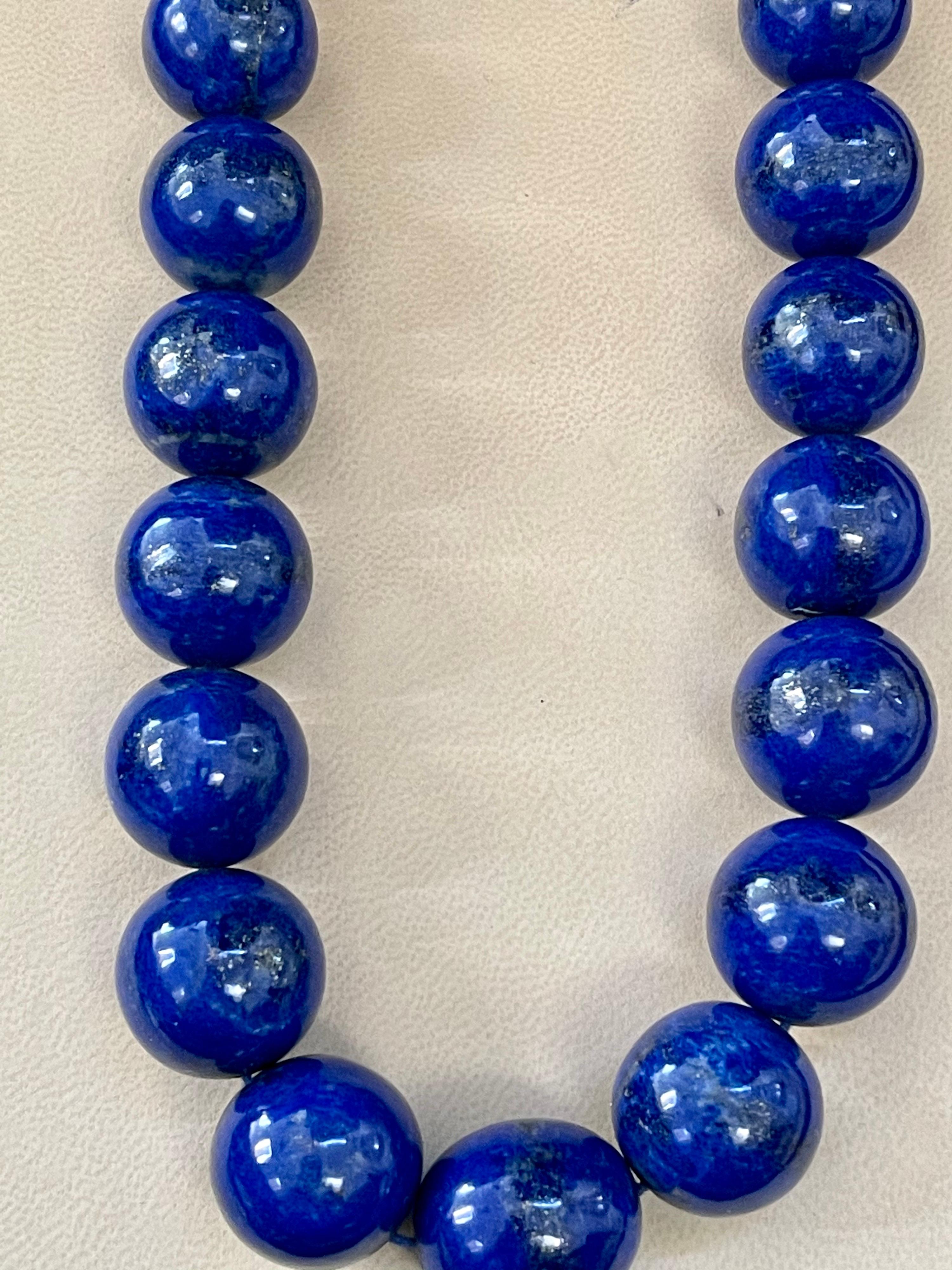 
Certified Lapis Lazuli Vintage Lapis Lazuli Single Strand Necklace with 1.1 Carat Diamond Ball Clasp in 14 Karat White Gold
This marvelous vintage Lapis Lazuli necklace features 1 row of luscious huge Beads
(measuring approximately from 25 MM to 17