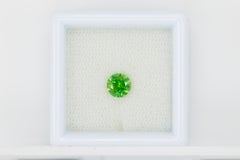 Certified vivd green faceted demantoid garnet, 0.69 ct