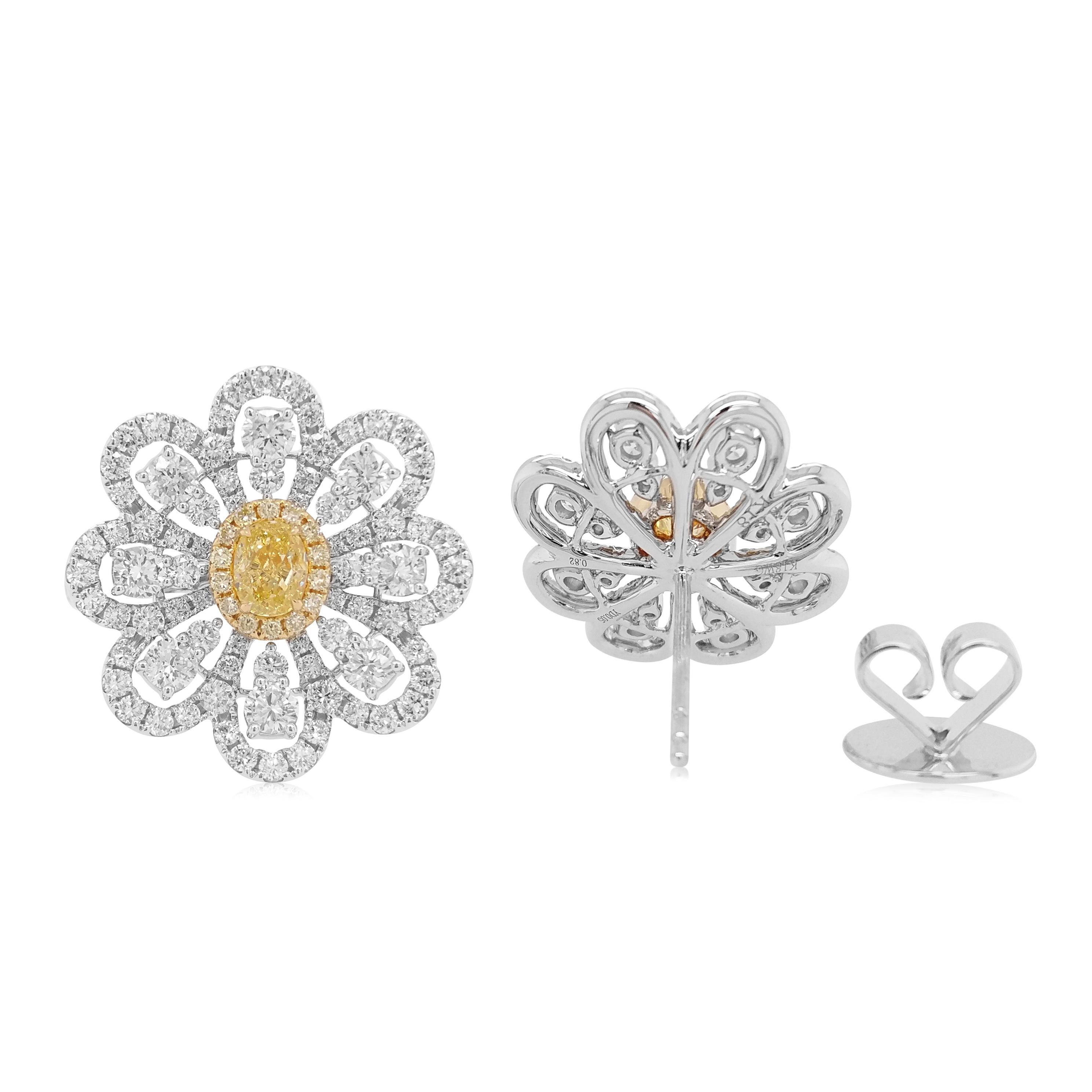 Natural Yellow Diamond Studded Earrings with Round Brilliant cut white diamonds creating a flower-like design are a beautiful addition to your jewelry collection.
-	Natural Fancy Yellow diamond (Oval), 0.393 carats (CGL, Japan Certified)
-	Round