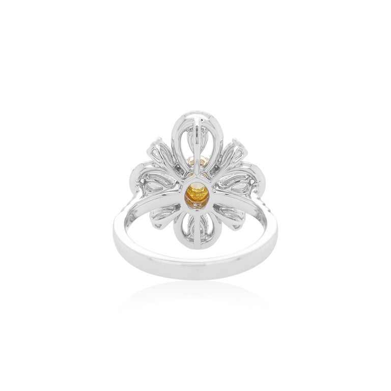 This ornate 18K gold ring features a lustrous Yellow diamond at its centre, with a small round-shape Yellow diamond halo, surrounded by scintillating pear-shape and round-shape white diamonds. Set in 18K white and yellow gold, dazzling and playful,