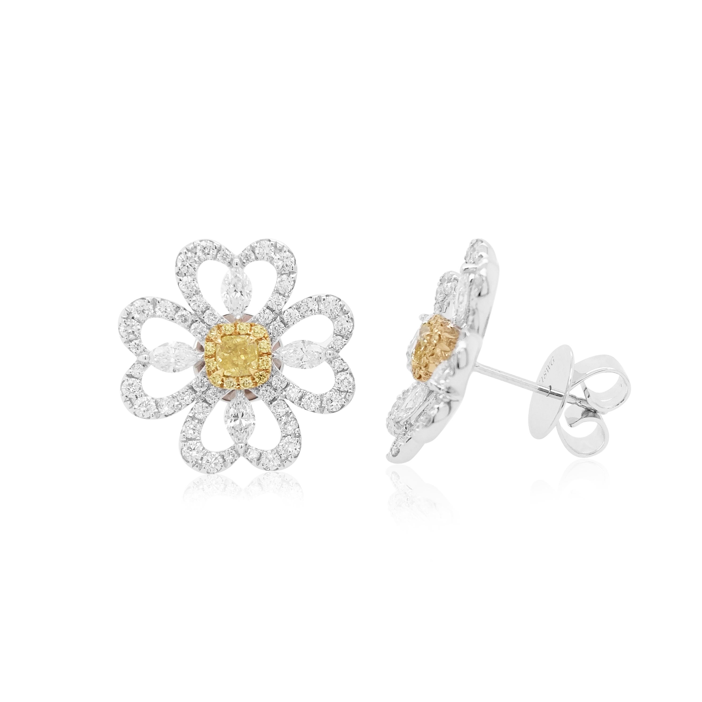 These unique flower shaped earrings feature natural Cushion-shape Yellow diamonds at the heart of their design. The rich colour of these diamonds is complimented perfectly by the delicate 18 Karat white gold floral design which completed by a
