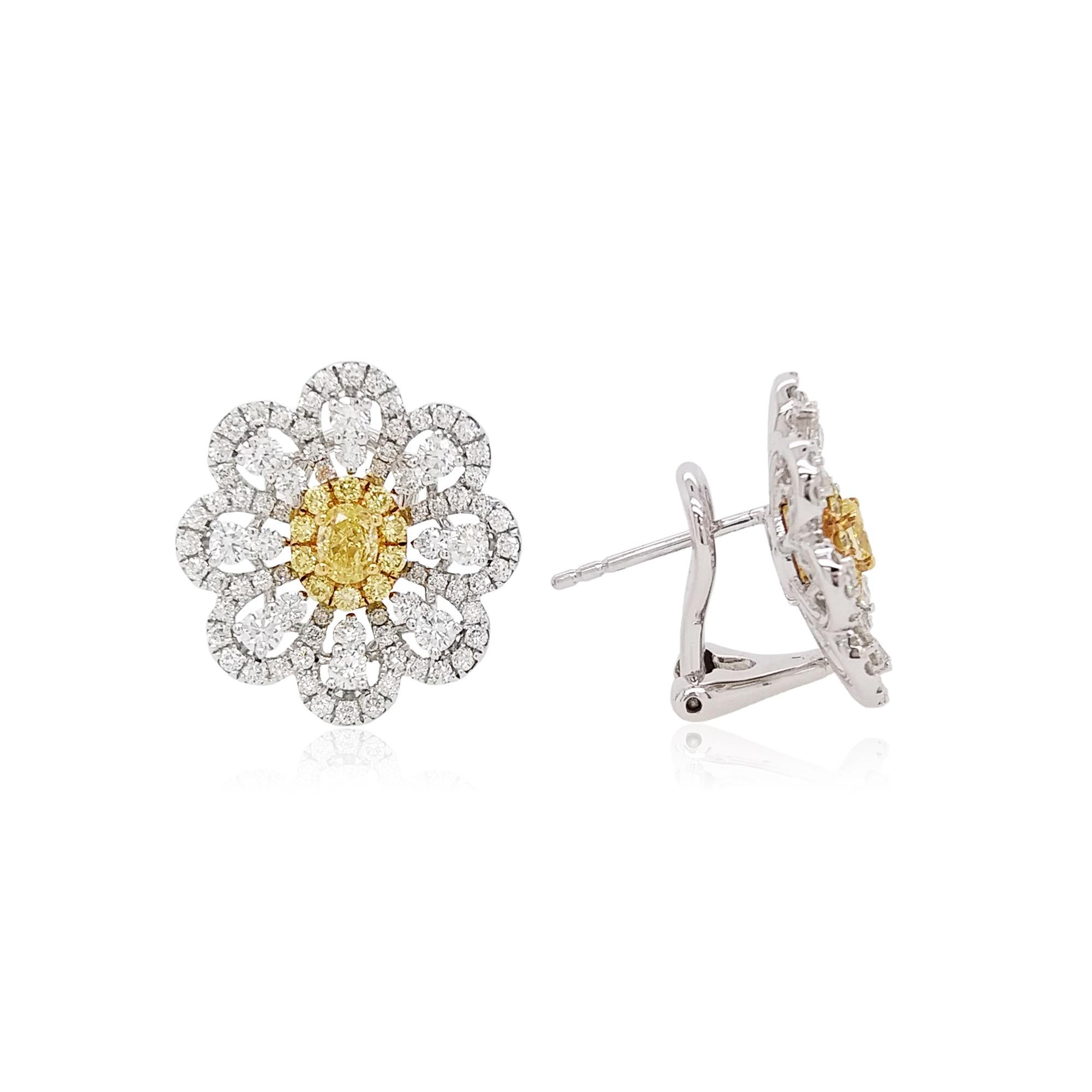 These floral K18 White gold earrings offer a subtle twist on a romantic design. Featuring Natural Fancy Intense Yellow Diamond at its centre, set amongst scintillating small yellow diamonds and sparkling white diamonds petals. These pretty earrings